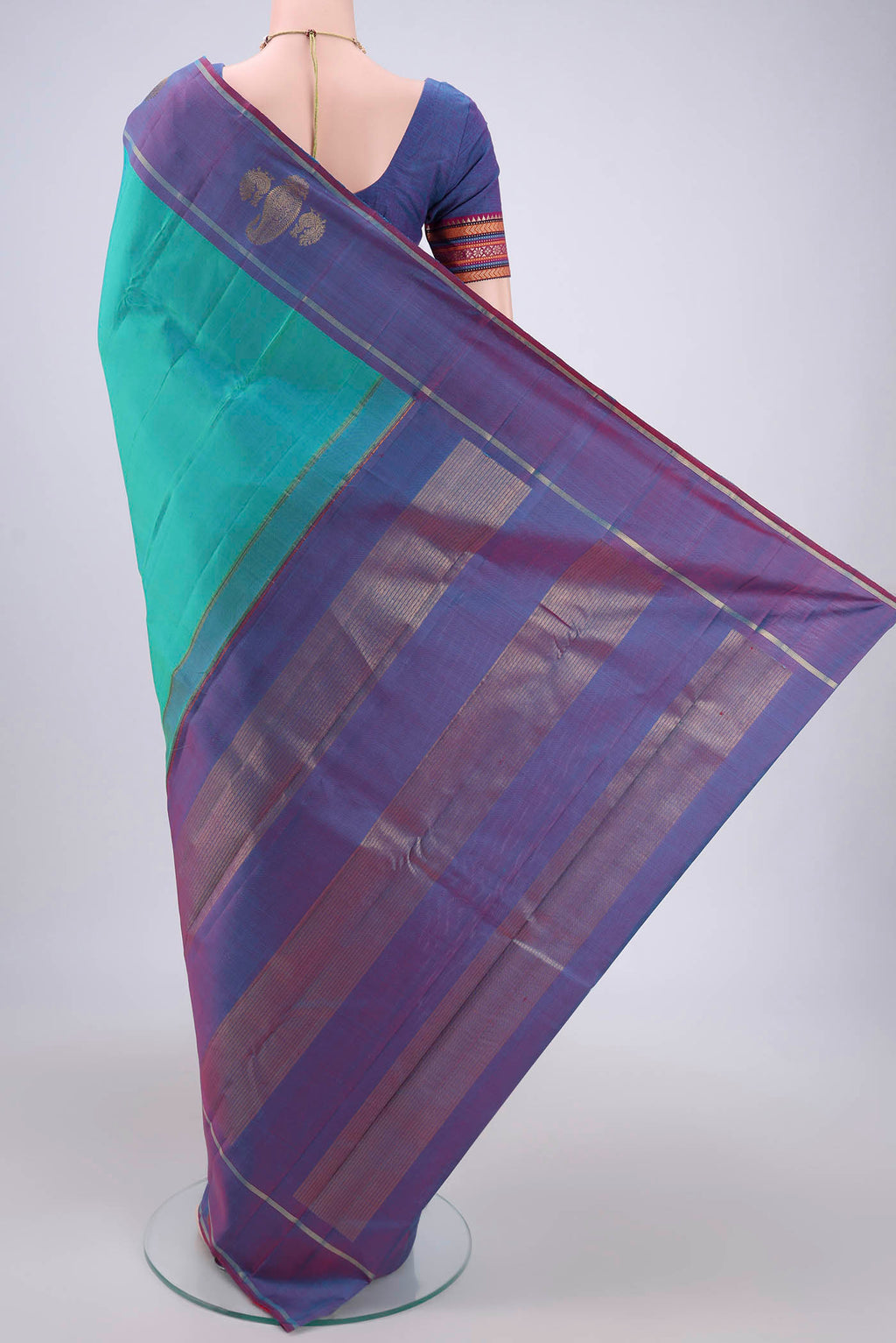 Flat view of Turquoise Dual Tone Kanchipuram Silk Saree with Plain Body and Attached Border. 