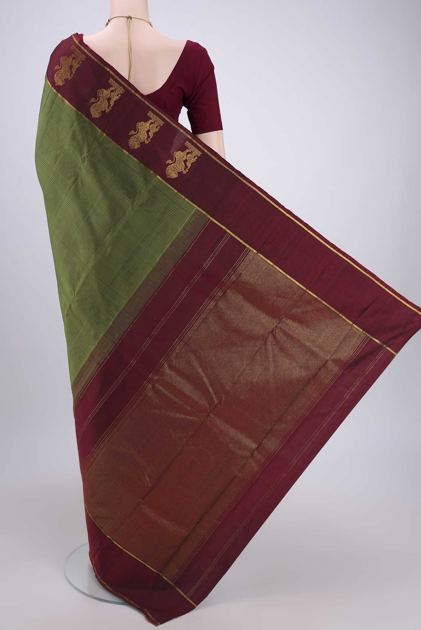 Flat view of Green Kanchipuram Silk Saree with Stripes on the body and Attached Border. 