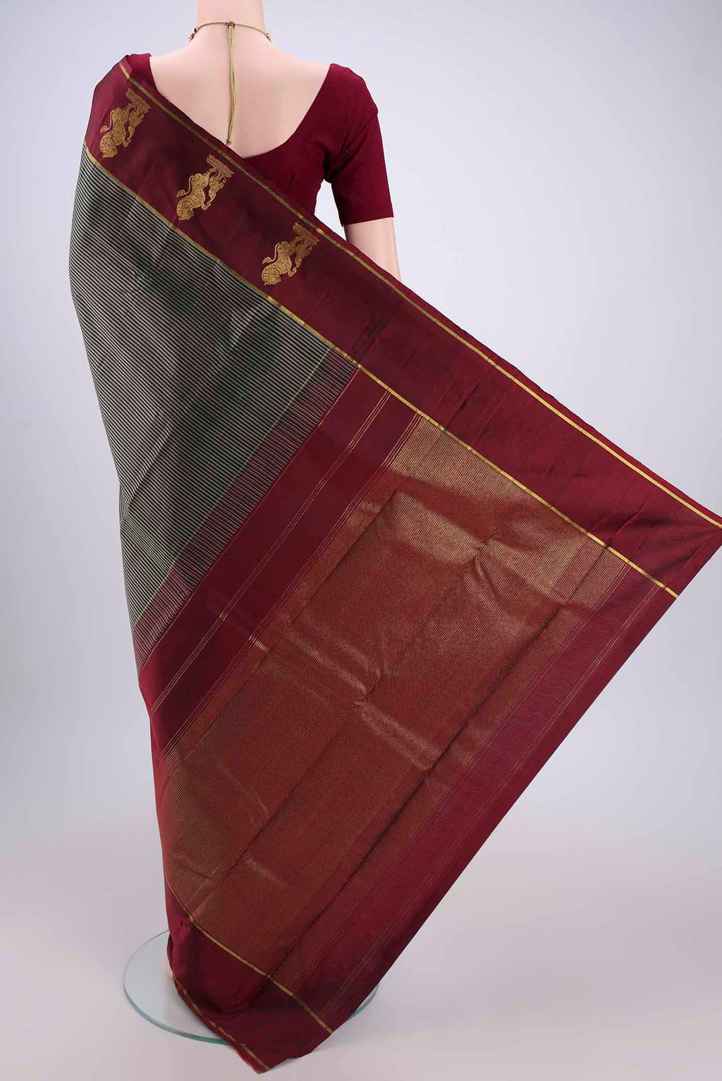 Flat view of Black Kanchipuram Silk Saree with Stripes on the body and Attached Border. 