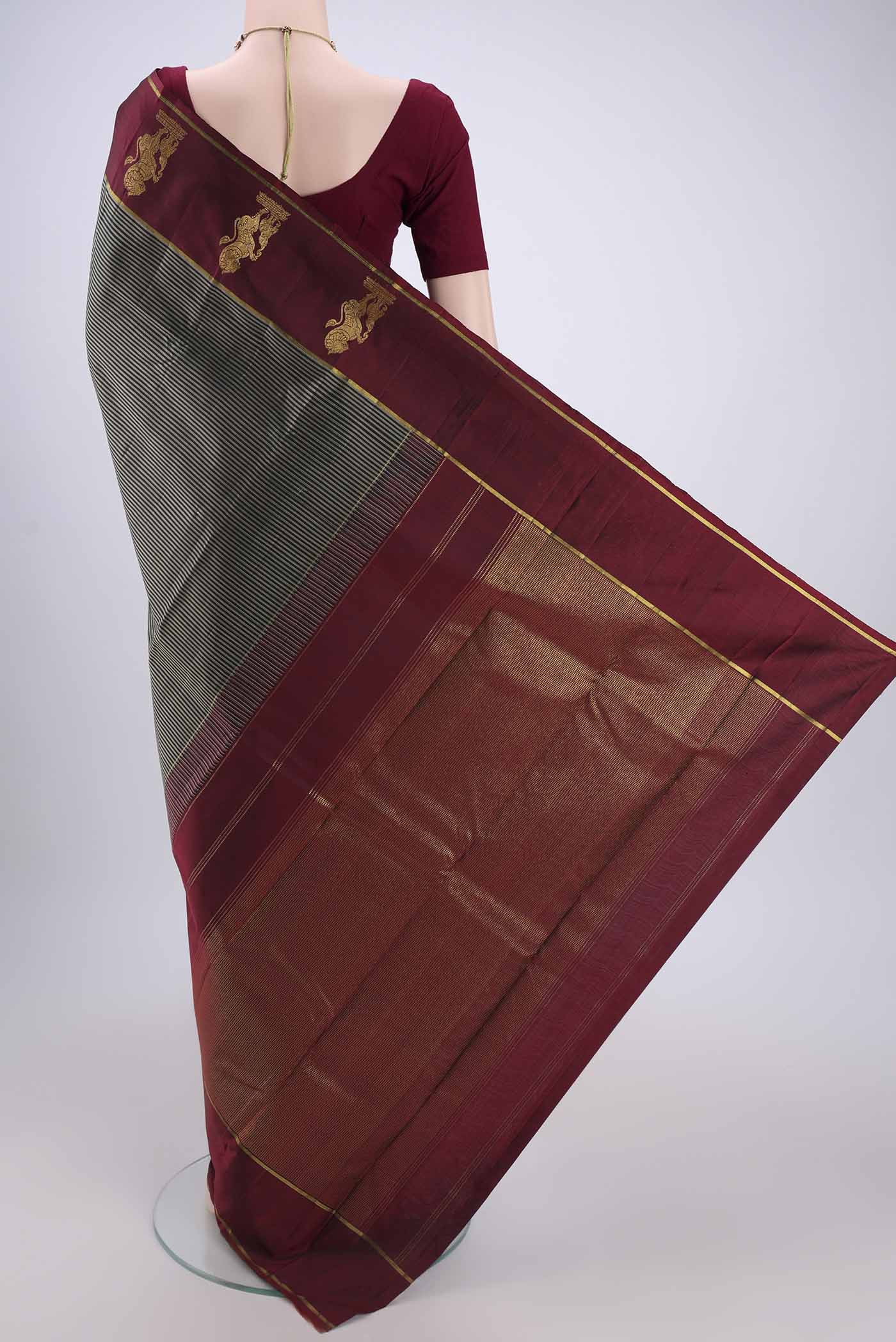 Flat view of Black Kanchipuram Silk Saree with Stripes on the body and Attached Border. 