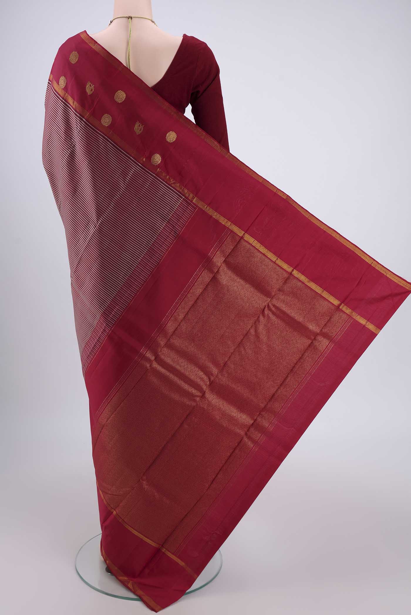 Flat view of Maroon Dual Tone Kanchipuram Silk Saree with Stripes on the body and Attached Border. 