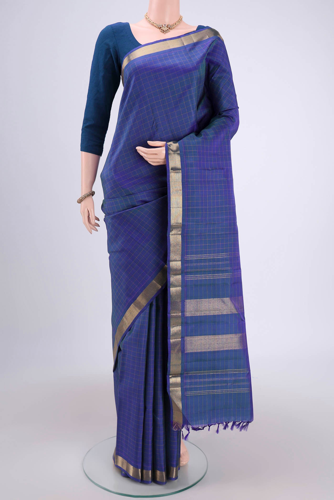 Blue Dual Tone Kanjivaram Silk Saree with Checked design on the body and Zari Border.  displayed on a mannequin