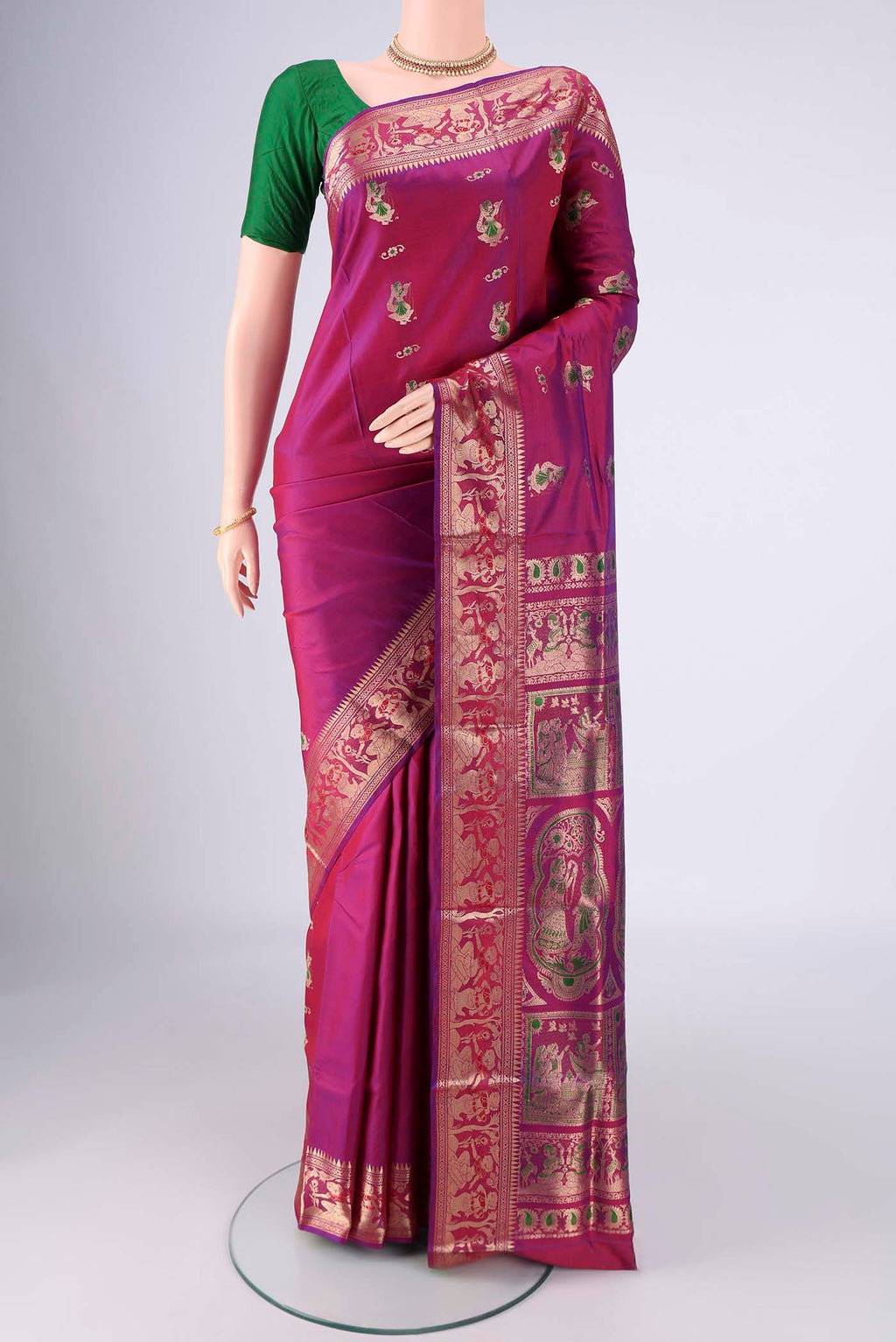 Magenta Baluchari Silk Saree with Zari And Thread Butta on the body and Zari And Thread Border.  displayed on a mannequin