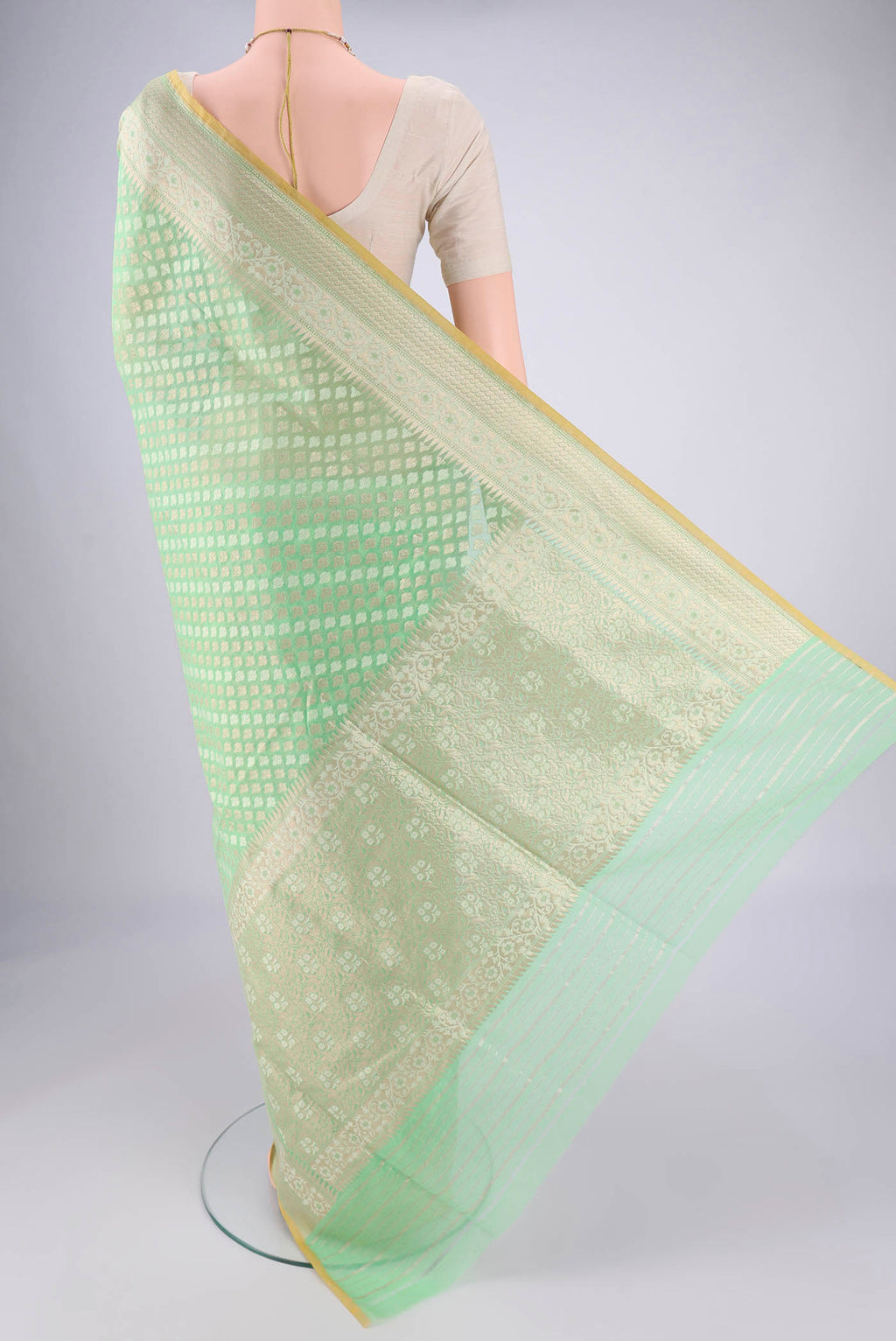 Flat view of Light Green Banarasi Silk Saree with Jacquard With Zari Butta on the body and Zari And Thread Border. 