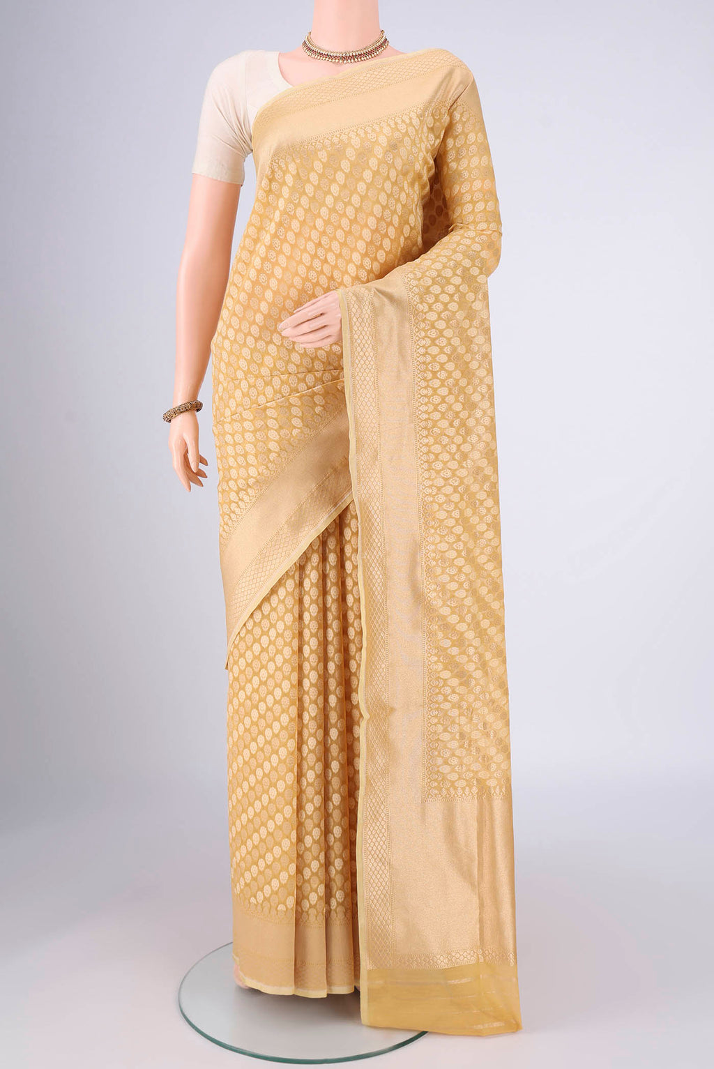 Sandal Banarasi Silk Saree with Jacquard With Zari Butta on the body and Zari Border.  displayed on a mannequin
