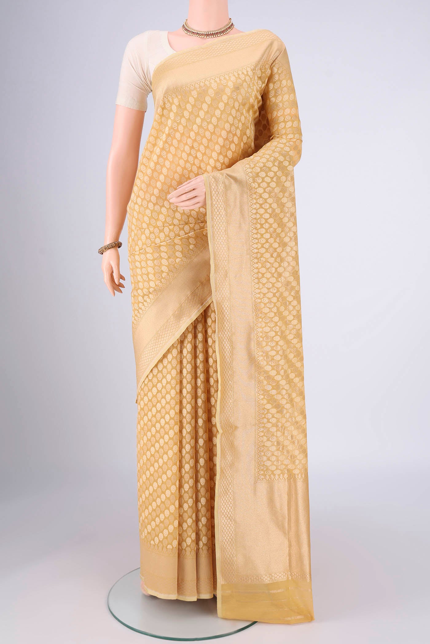 Sandal Banarasi Silk Saree with Jacquard With Zari Butta on the body and Zari Border.  displayed on a mannequin