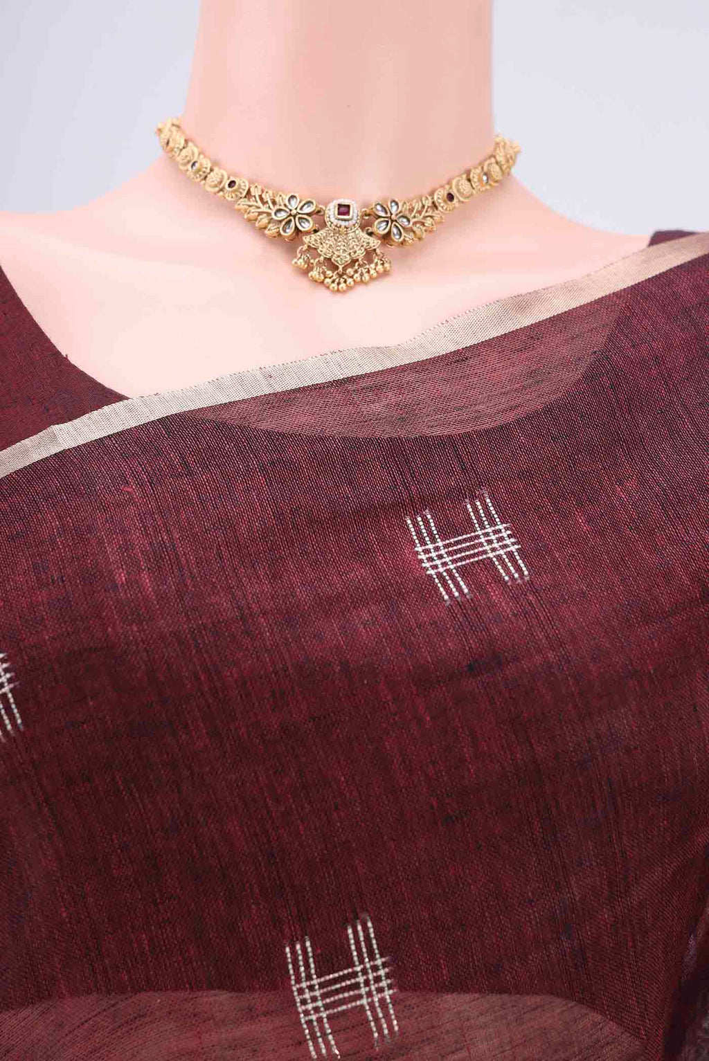 Border image of Maroon Blended Linen Saree with Thread Butta on the body and Zari Border. 
