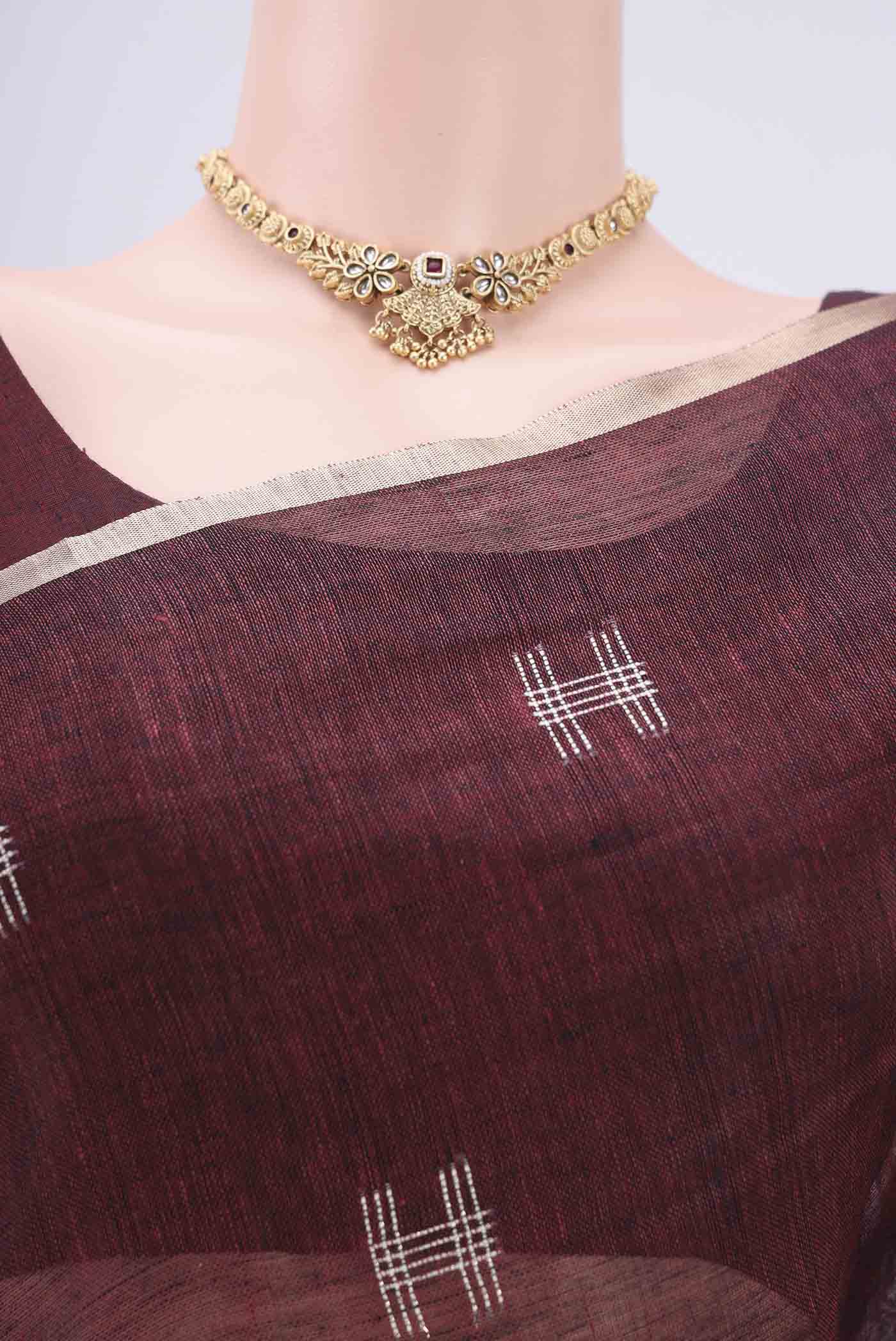 Border image of Maroon Blended Linen Saree with Thread Butta on the body and Zari Border. 