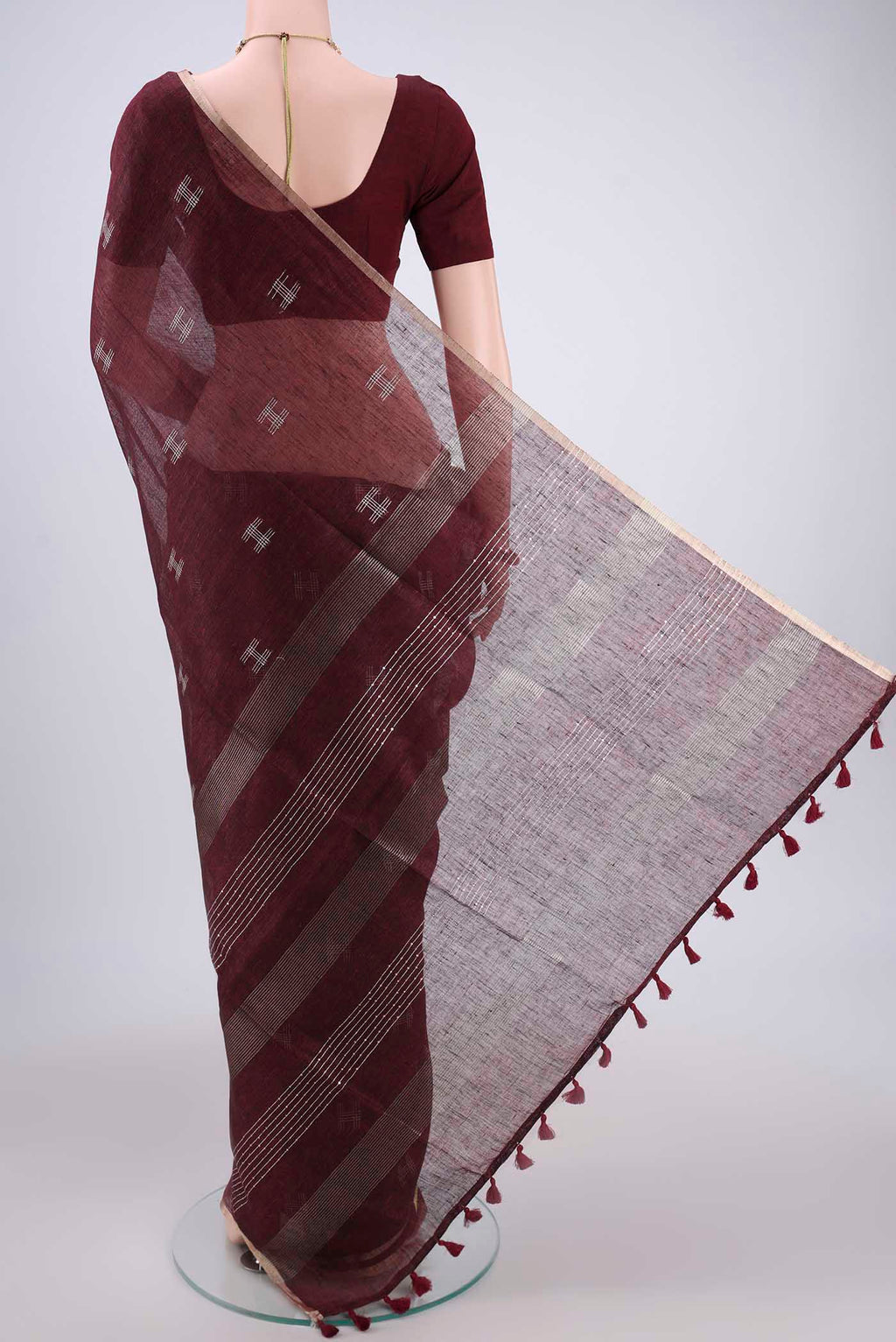Flat view of Maroon Blended Linen Saree with Thread Butta on the body and Zari Border. 