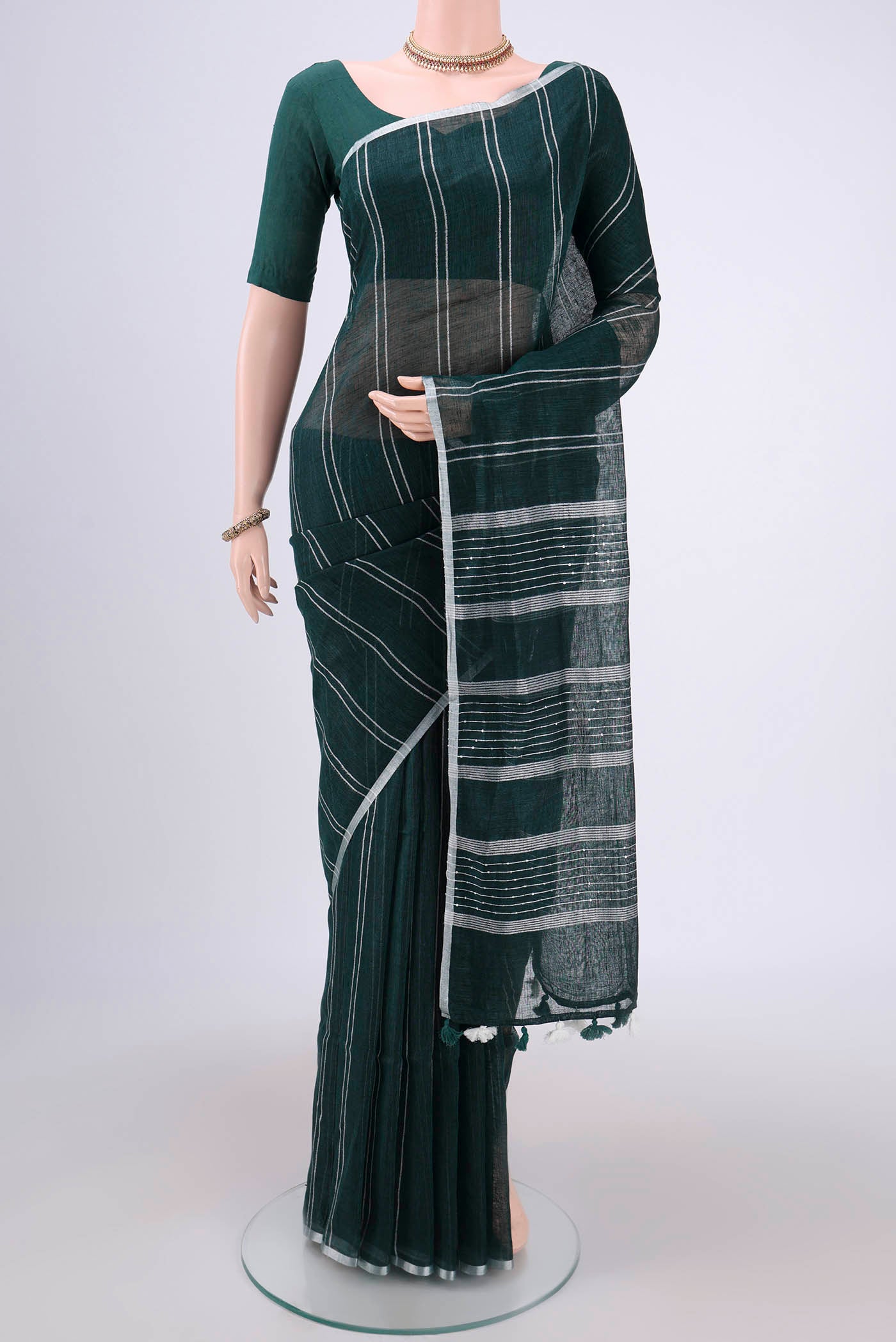 Bottle Green Blended Linen Saree with Stripes on the body and Zari Border.  displayed on a mannequin