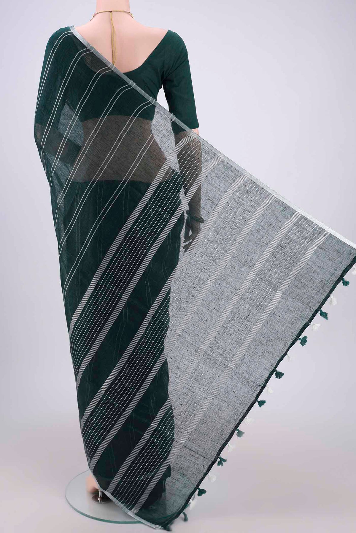 Flat view of Bottle Green Blended Linen Saree with Stripes on the body and Zari Border. 
