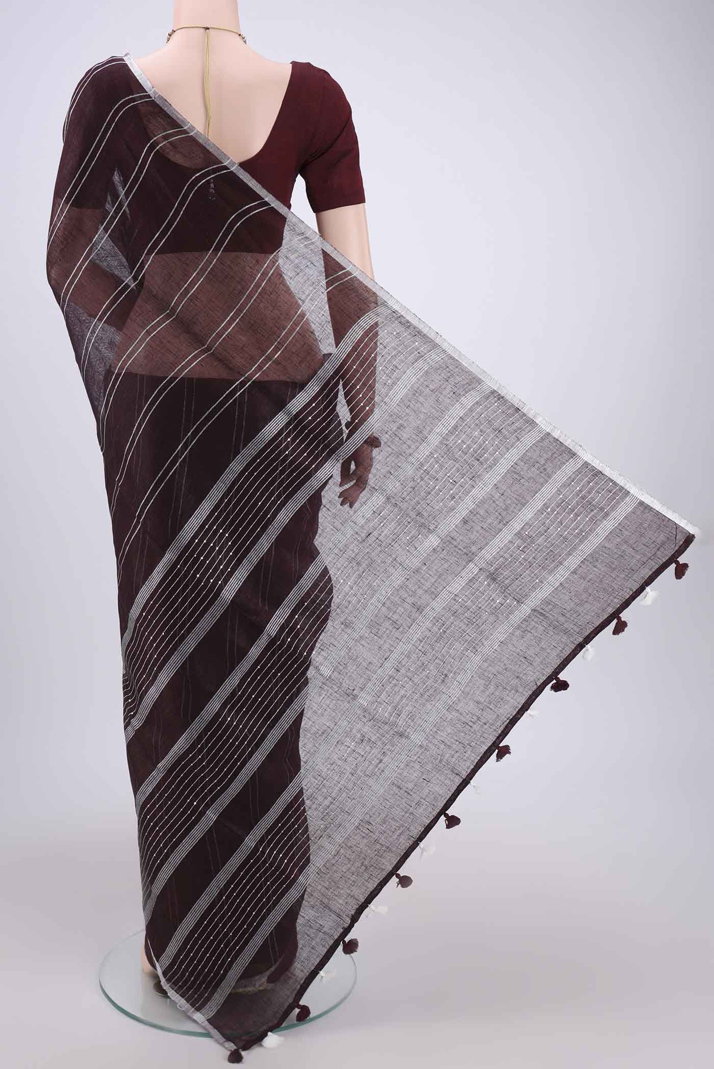 Flat view of Brown Blended Linen Saree with Stripes on the body and Zari Border. 