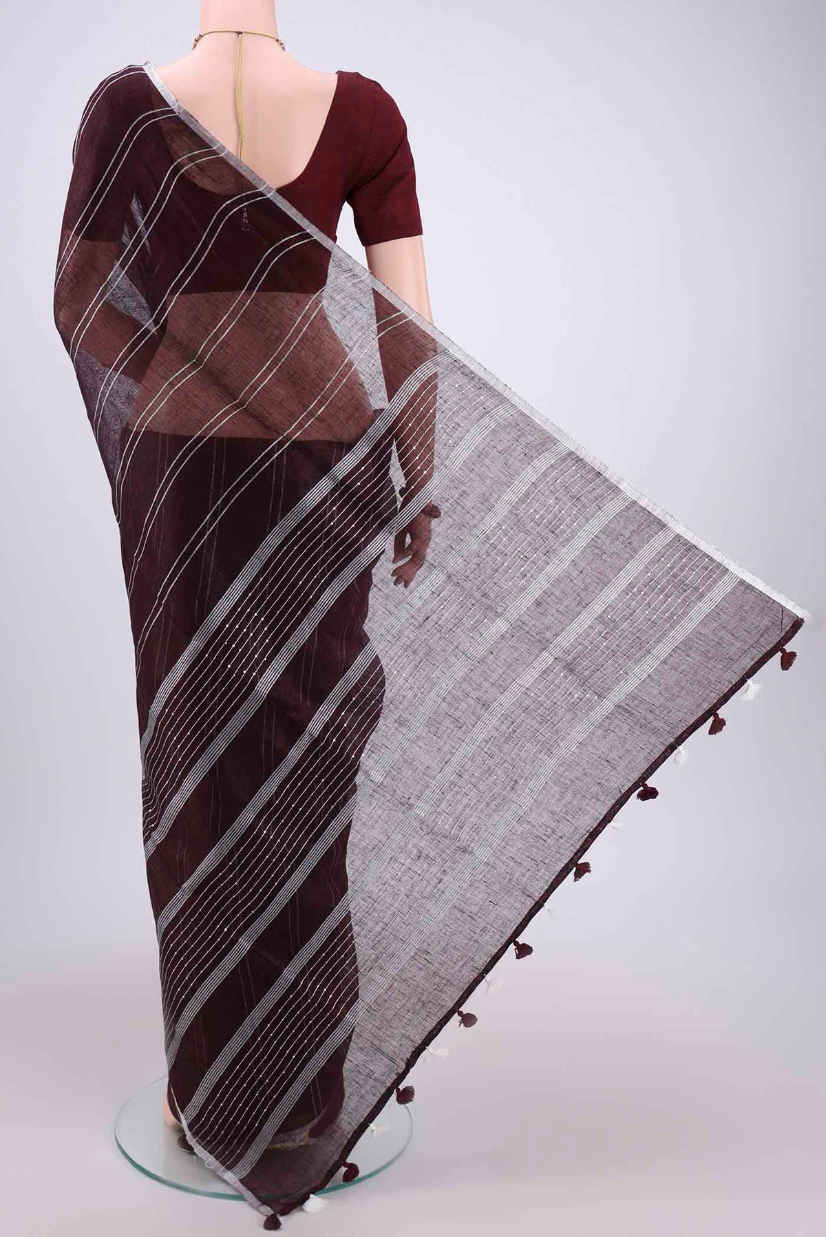 Flat view of Brown Blended Linen Saree with Stripes on the body and Zari Border. 