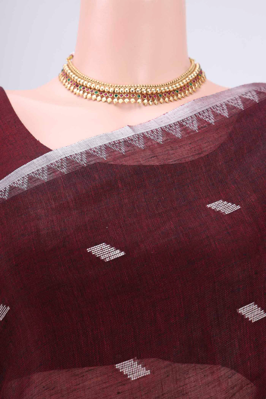 Border image of Maroon Blended Linen Saree with Thread Butta on the body and Zari Border. 