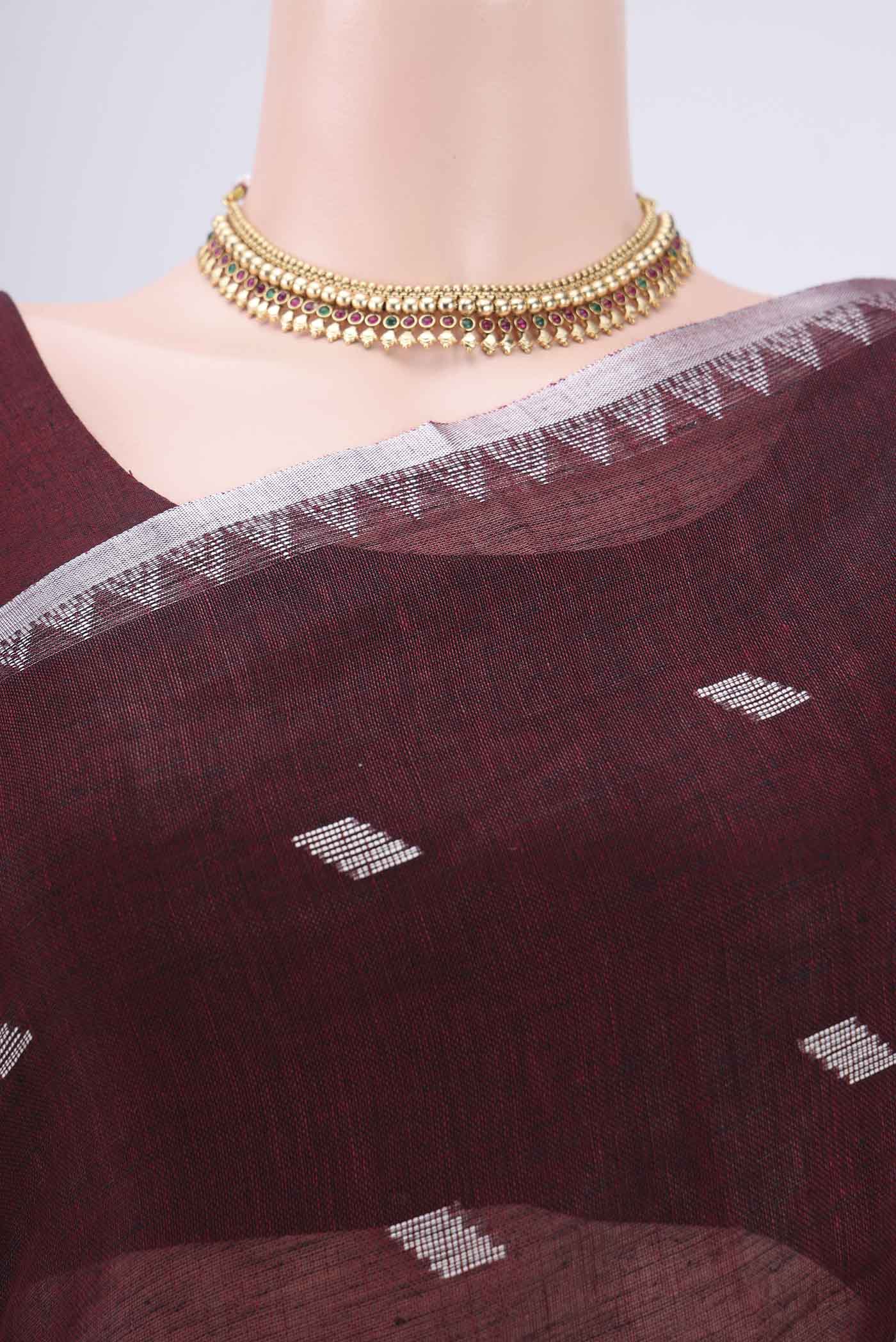 Border image of Maroon Blended Linen Saree with Thread Butta on the body and Zari Border. 
