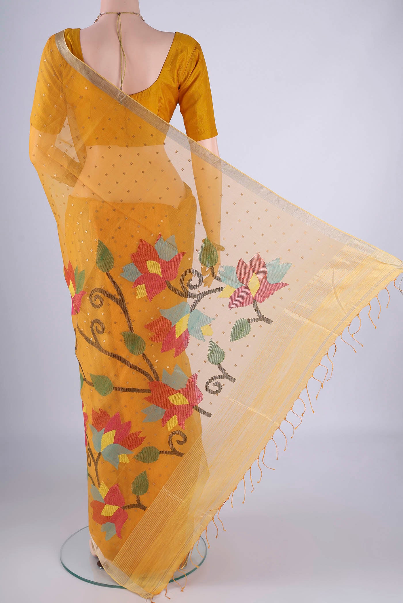 Flat view of Yellow Muslin Silk Saree with Embroidery on the body and Zari Border. 