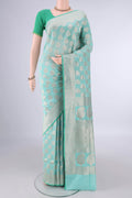 Pure Silk Mint Green Banarasi Saree with Zari Butta on the body and Zari Border.  displayed on a mannequin