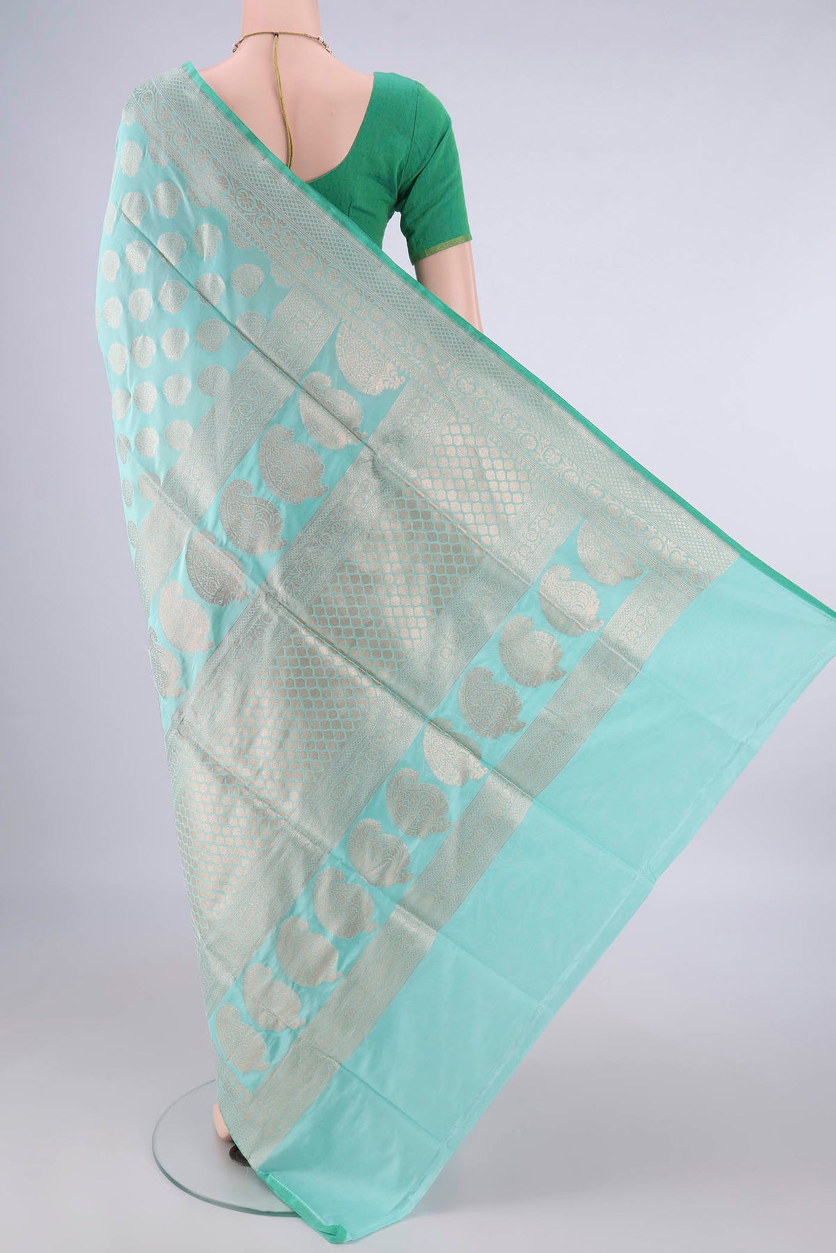 Flat view of Pure Silk Mint Green Banarasi Saree with Zari Butta on the body and Zari Border. 