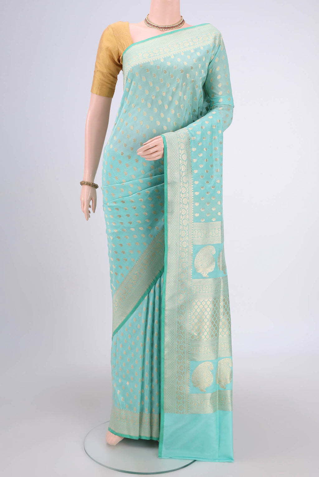 Mint Green Dual Tone Banarasi Silk Saree with Zari Butta on the body and Zari Border.  displayed on a mannequin