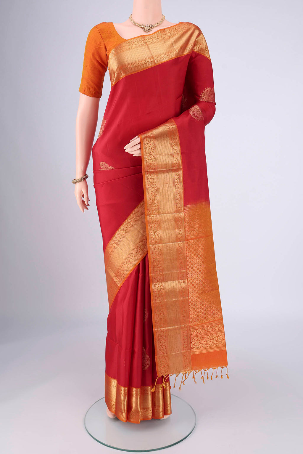 Maroon Soft Silk Saree with Zari Butta on the body and Zari Border.  displayed on a mannequin