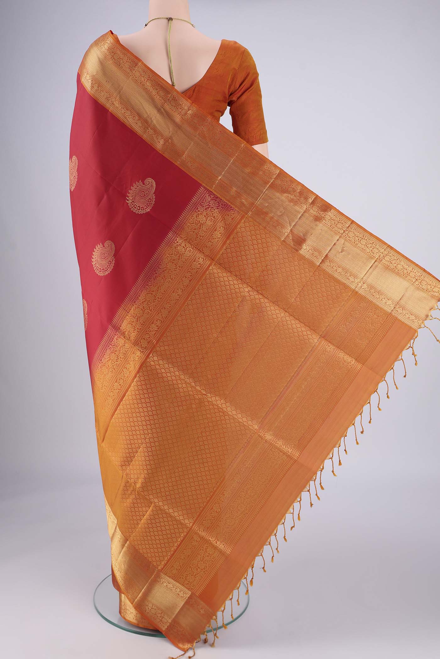 Flat view of Maroon Soft Silk Saree with Zari Butta on the body and Zari Border. 