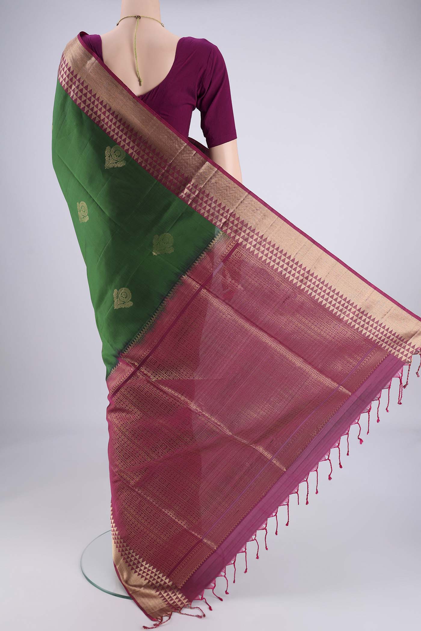 Flat view of Bottle Green Soft Silk Saree with Zari Butta on the body and Zari Border. 