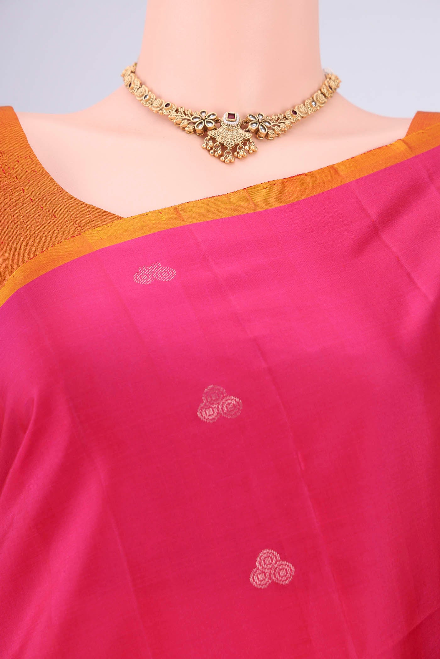 Border image of Rani Pink Soft Silk Saree with Zari Butta on the body and Plain Border. 