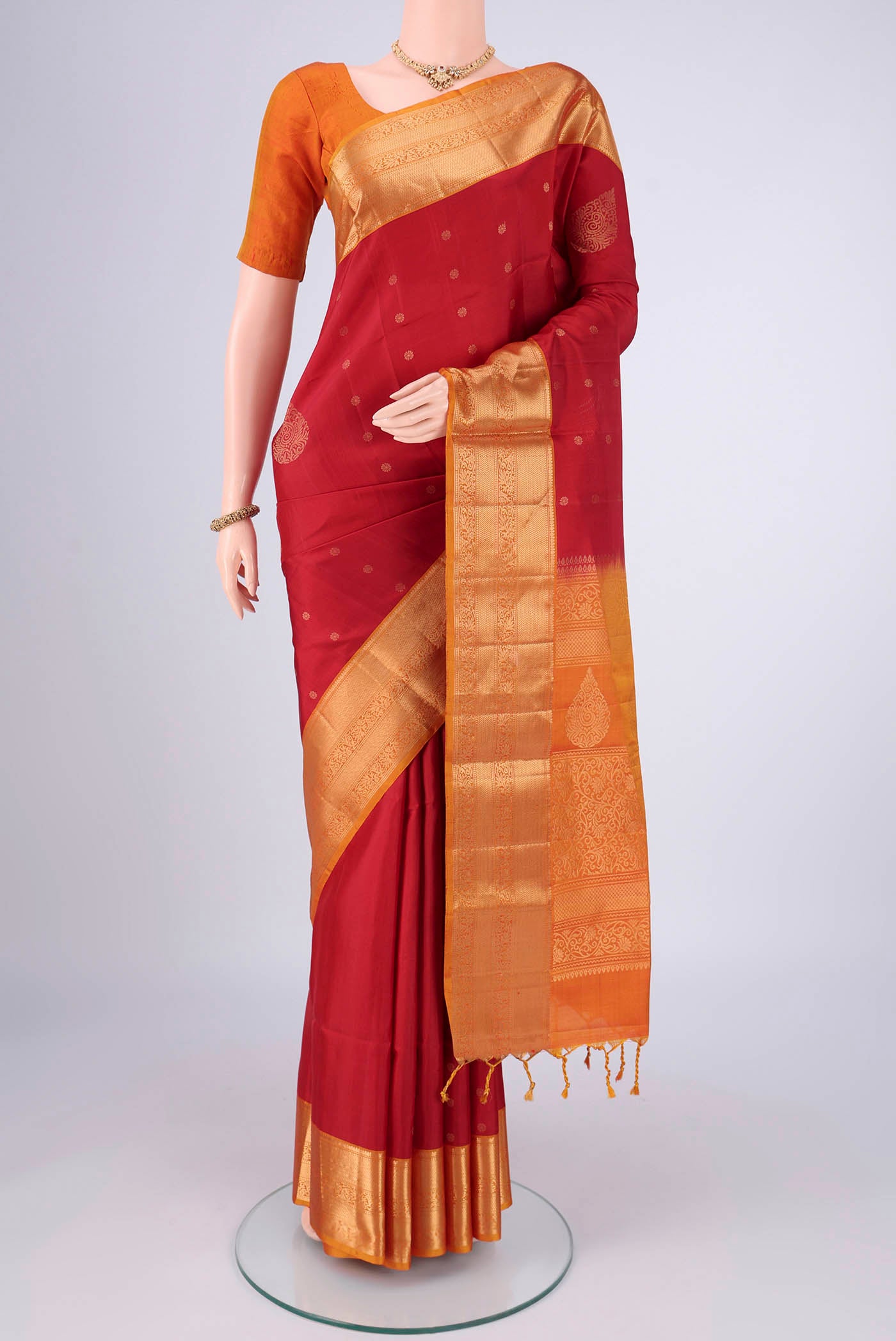 Maroon Soft Silk Saree with Zari Butta on the body and Zari Border.  displayed on a mannequin