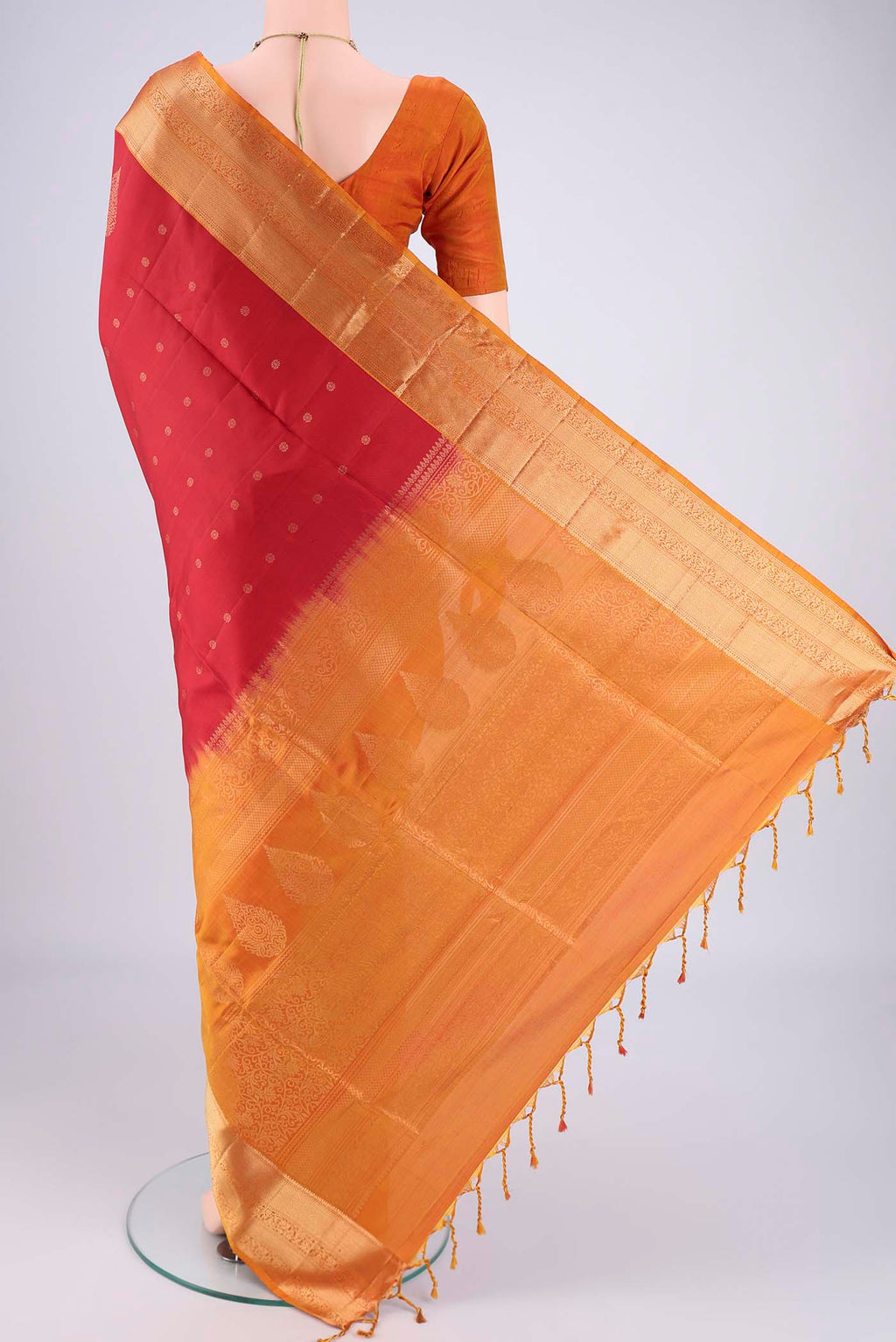 Flat view of Maroon Soft Silk Saree with Zari Butta on the body and Zari Border. 