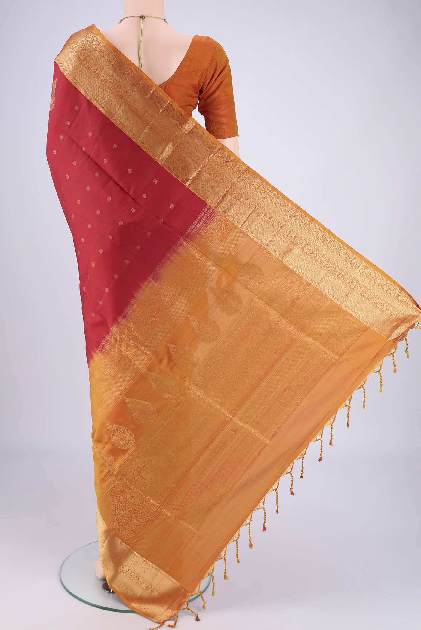 Flat view of Maroon Soft Silk Saree with Zari Butta on the body and Zari Border. 