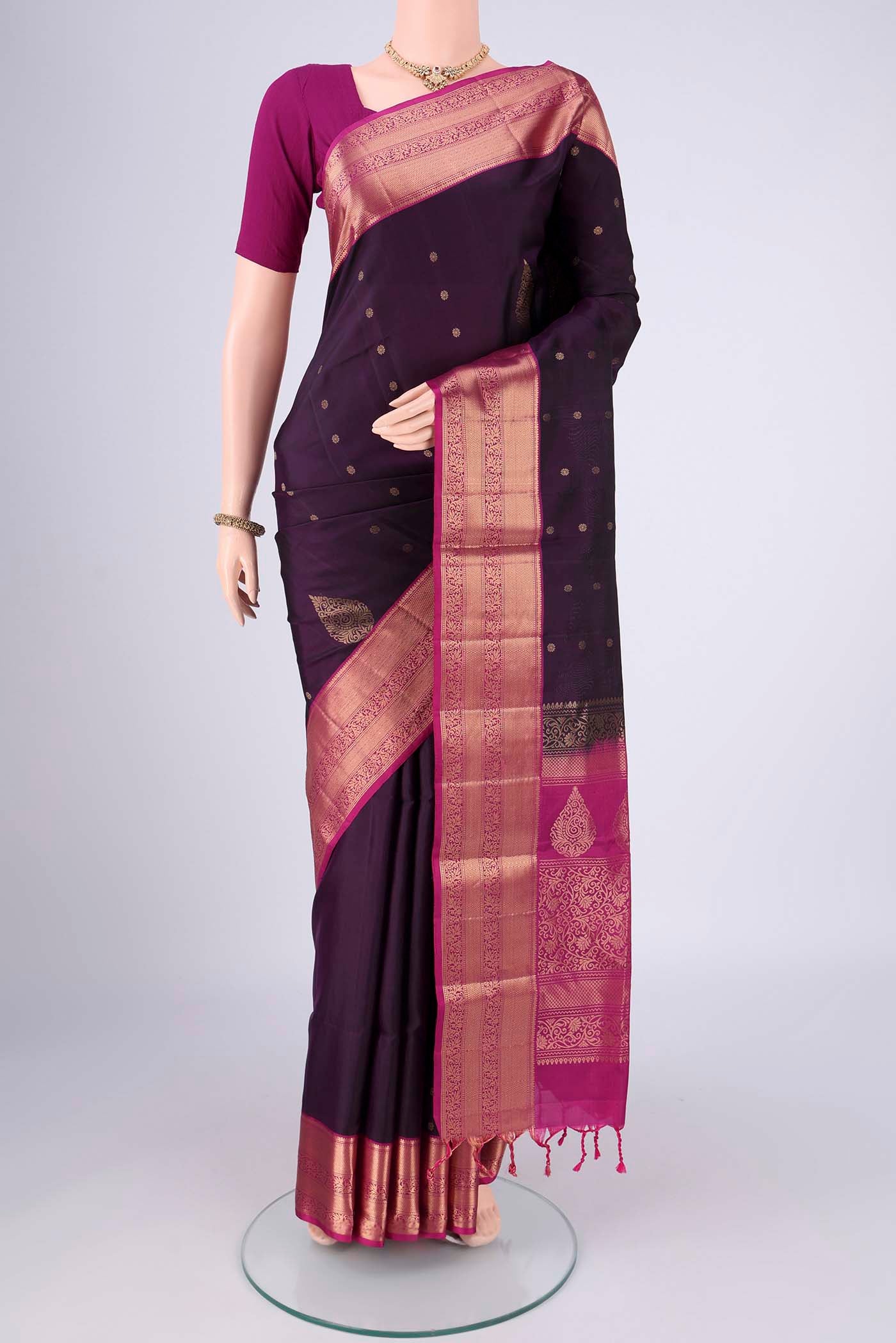 Purple Soft Silk Saree with Zig Zag design on the body and Zari Border.  displayed on a mannequin