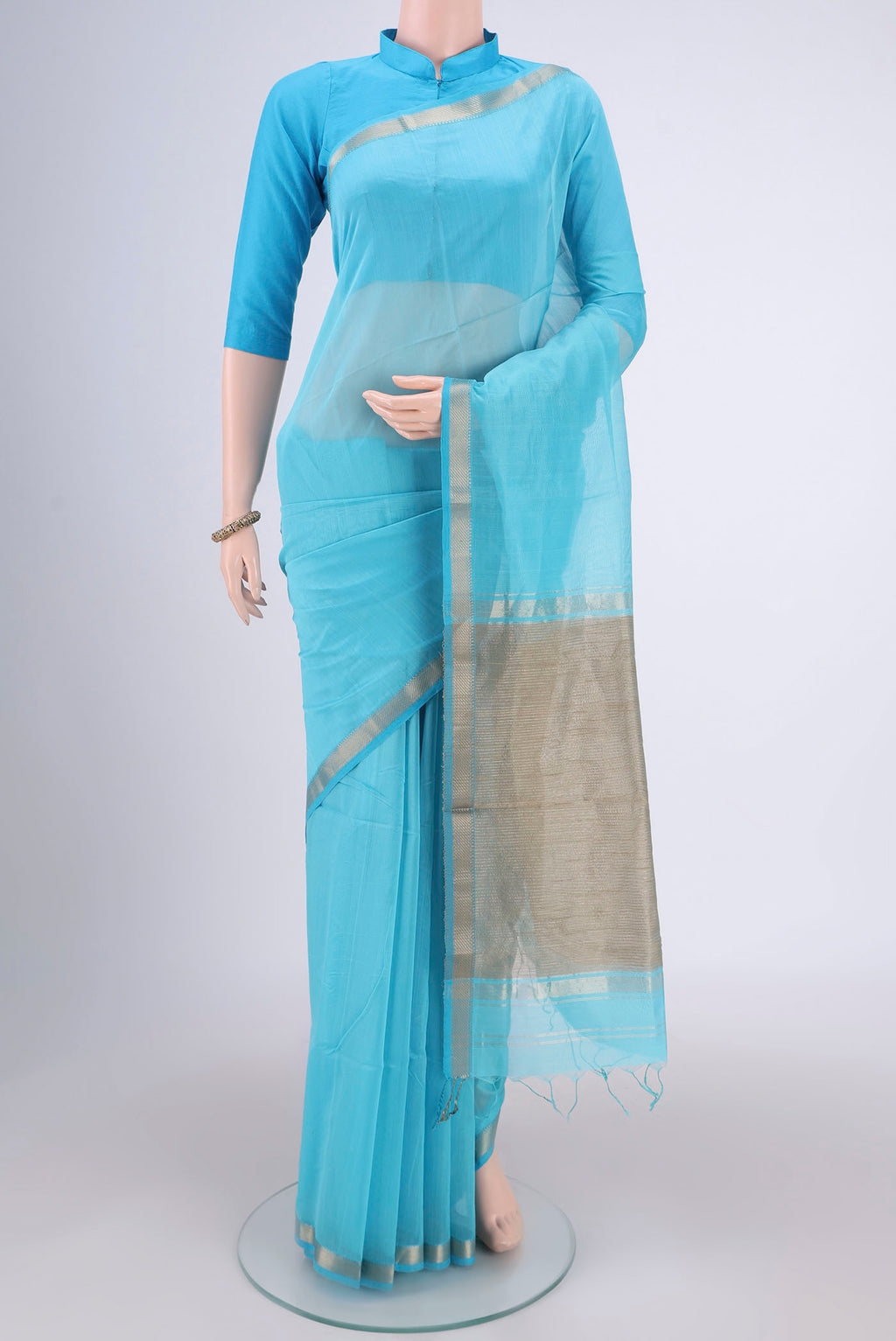 Blue Maheshwari Silk Cotton Saree with Plain Body and Zari Border.  displayed on a mannequin