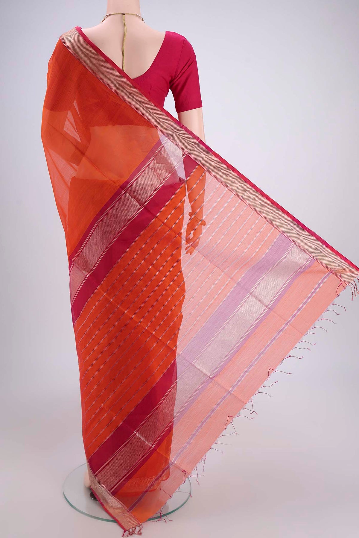 Flat view of Orange Maheshwari Silk Cotton Saree with Plain Body and Thread Border. 