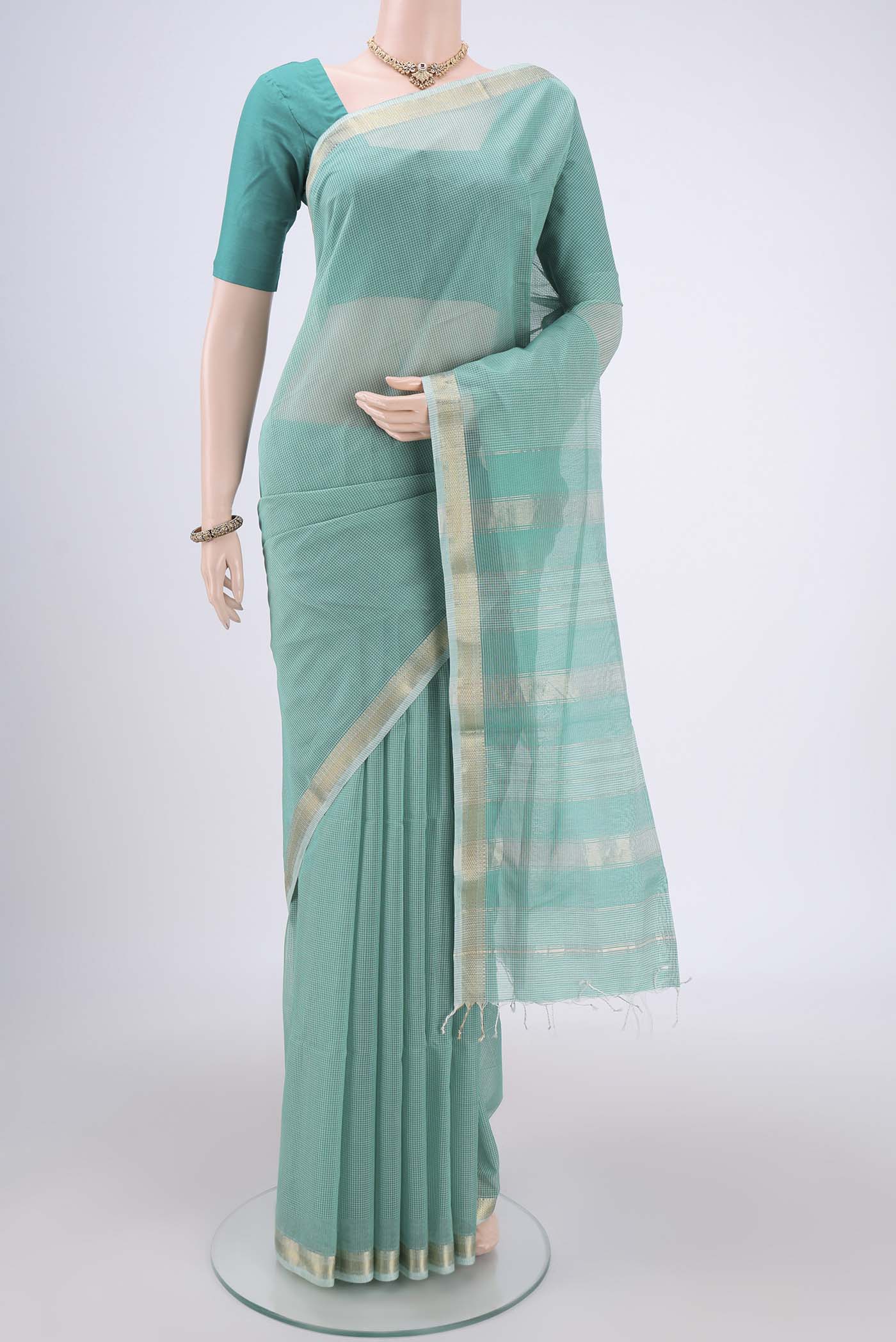 Sea Green Maheshwari Silk Cotton Saree with Checked design on the body and Zari Border.  displayed on a mannequin