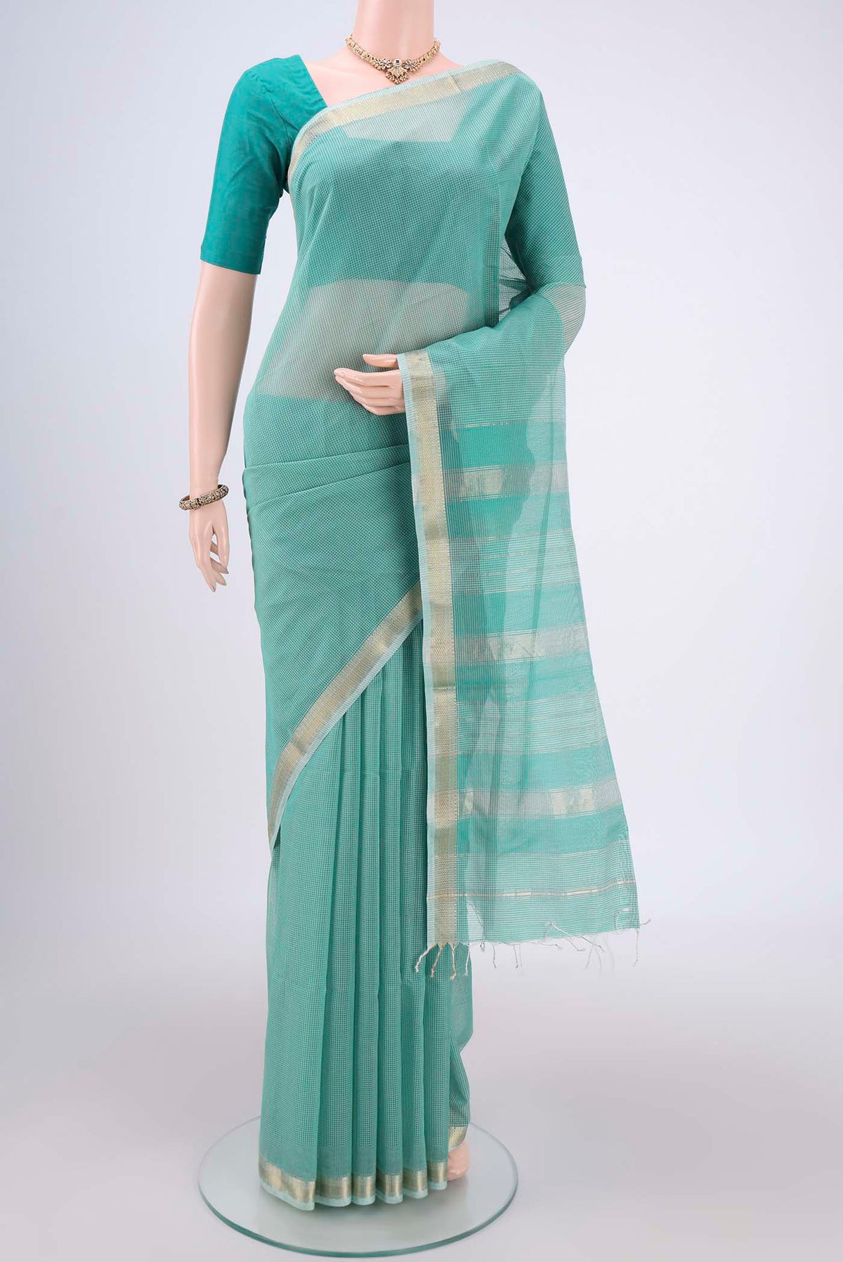 Sea Green Maheshwari Silk Cotton Saree with Checked design on the body and Zari Border.  displayed on a mannequin