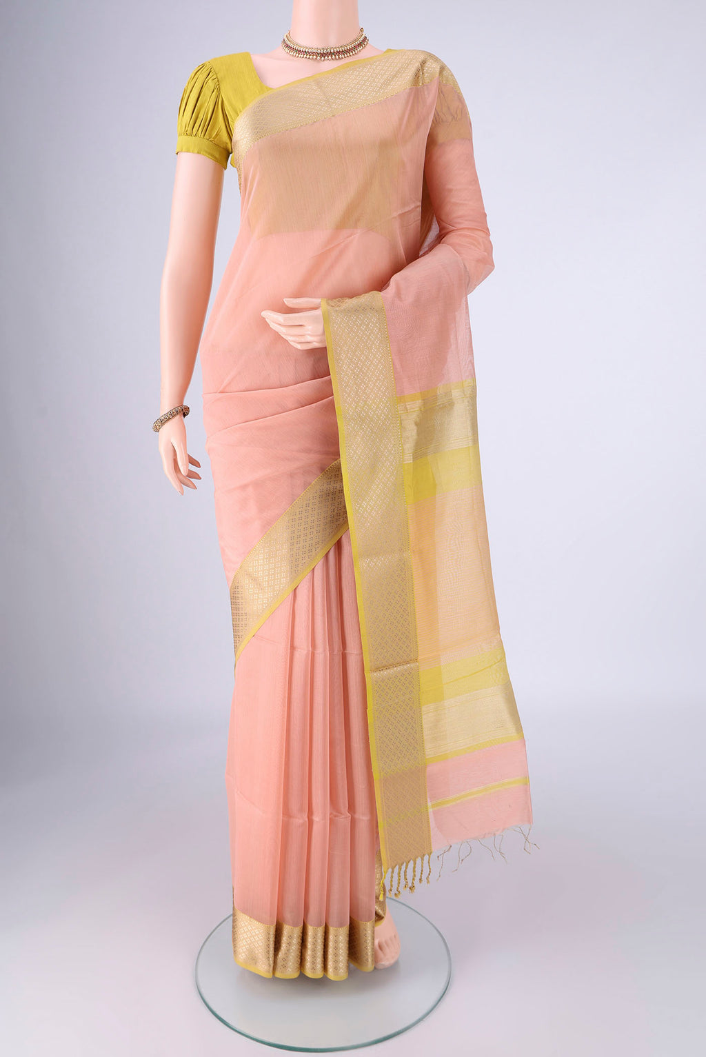 Peach Dual Tone Maheshwari Silk Cotton Saree with Plain Body and Thread Border.  displayed on a mannequin