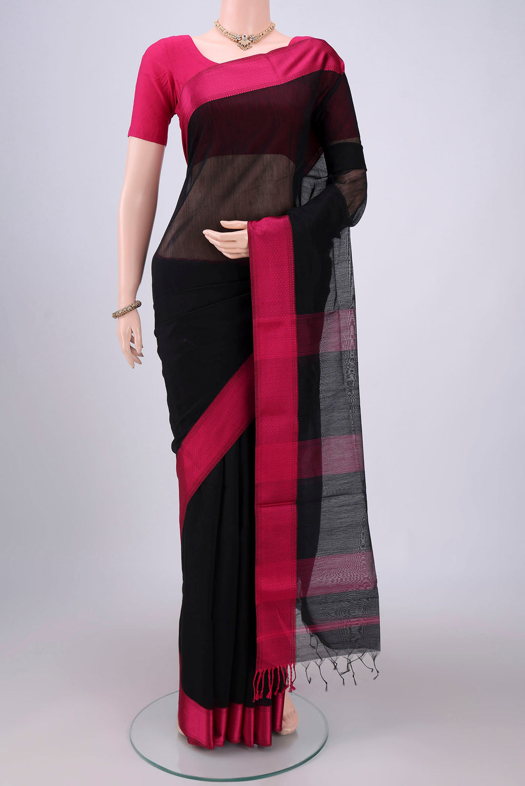 Black Maheshwari Silk Cotton Saree with Plain Body and Thread Border.  displayed on a mannequin