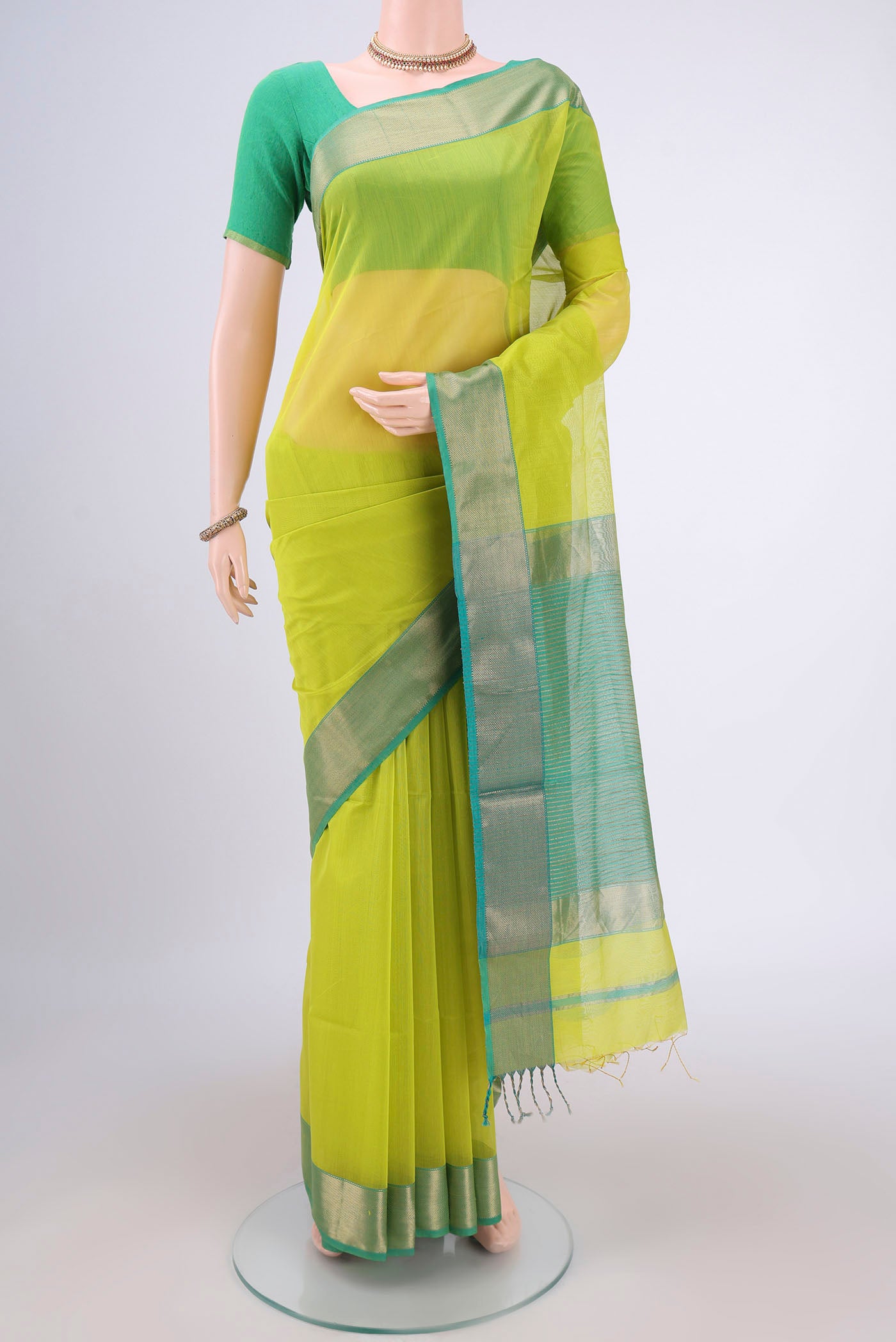 Acid Green Maheshwari Silk Cotton Saree with Plain Body and Zari Border.  displayed on a mannequin