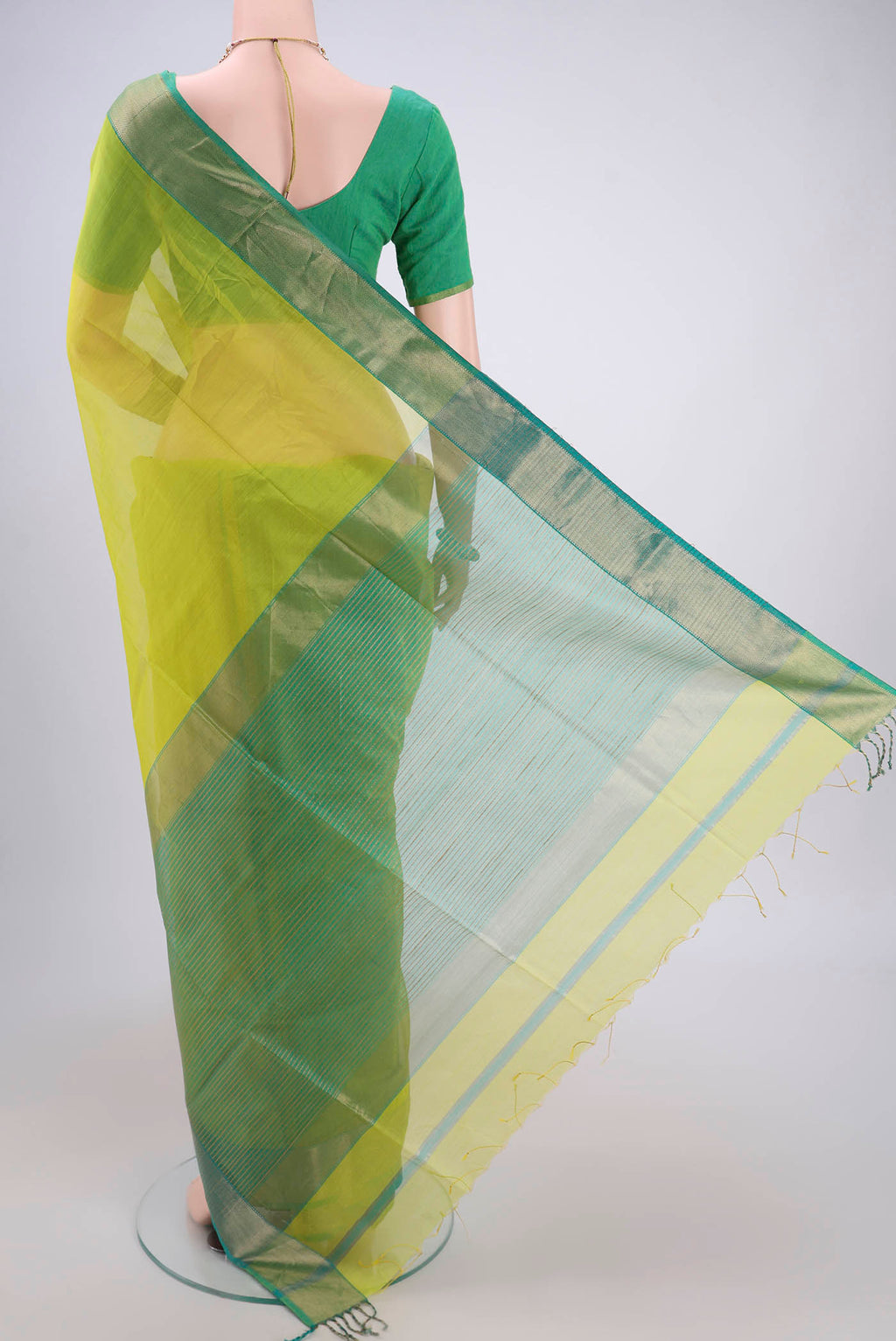 Flat view of Acid Green Maheshwari Silk Cotton Saree with Plain Body and Zari Border. 