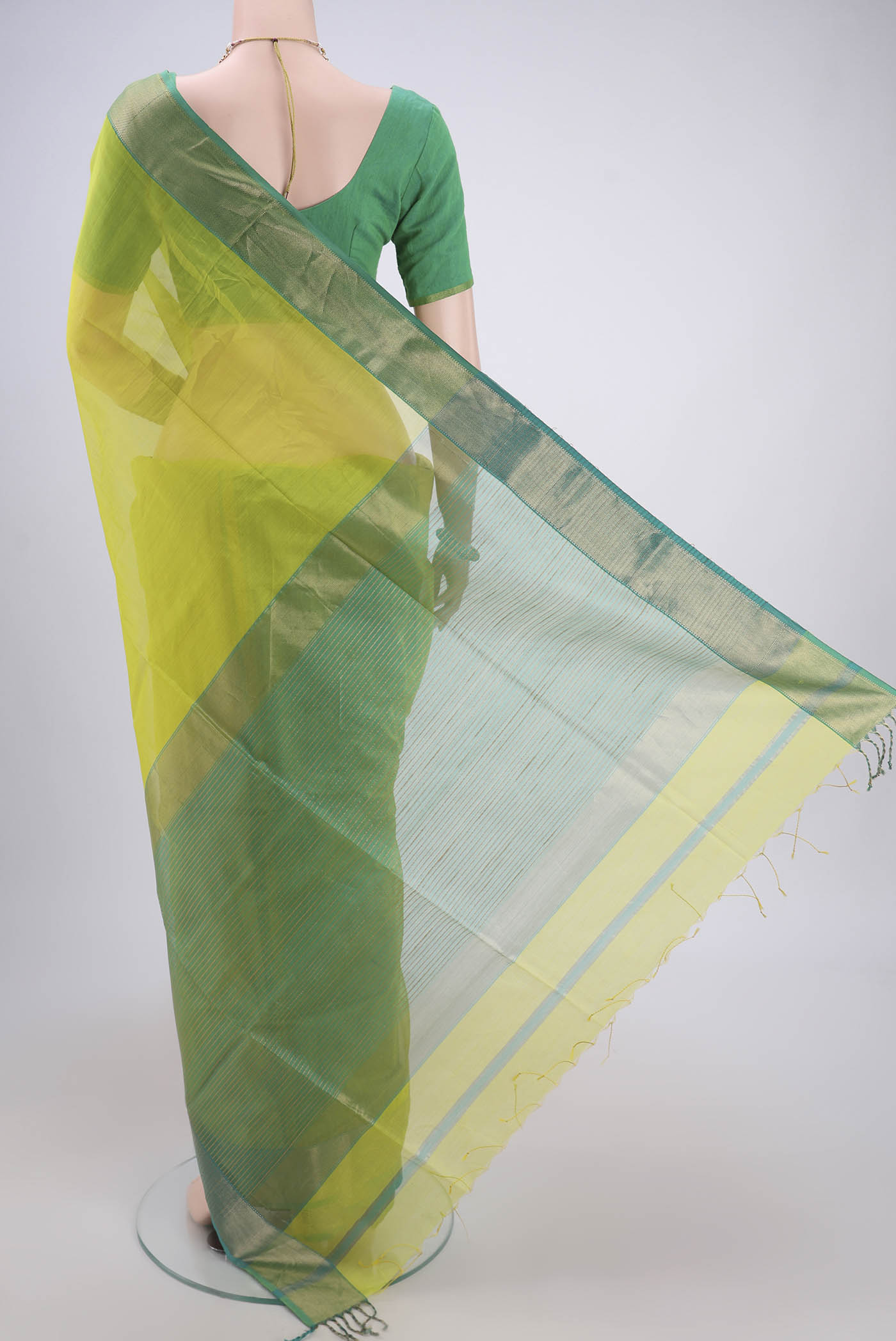 Flat view of Acid Green Maheshwari Silk Cotton Saree with Plain Body and Zari Border. 