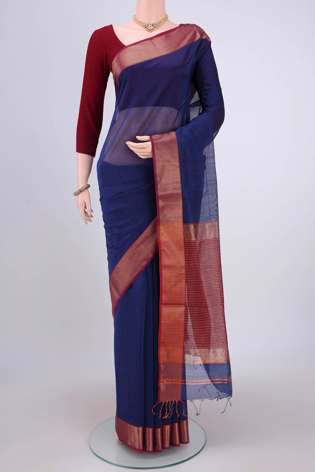 Purple Maheshwari Silk Cotton Saree with Stripes on the body and Zari Border.  displayed on a mannequin