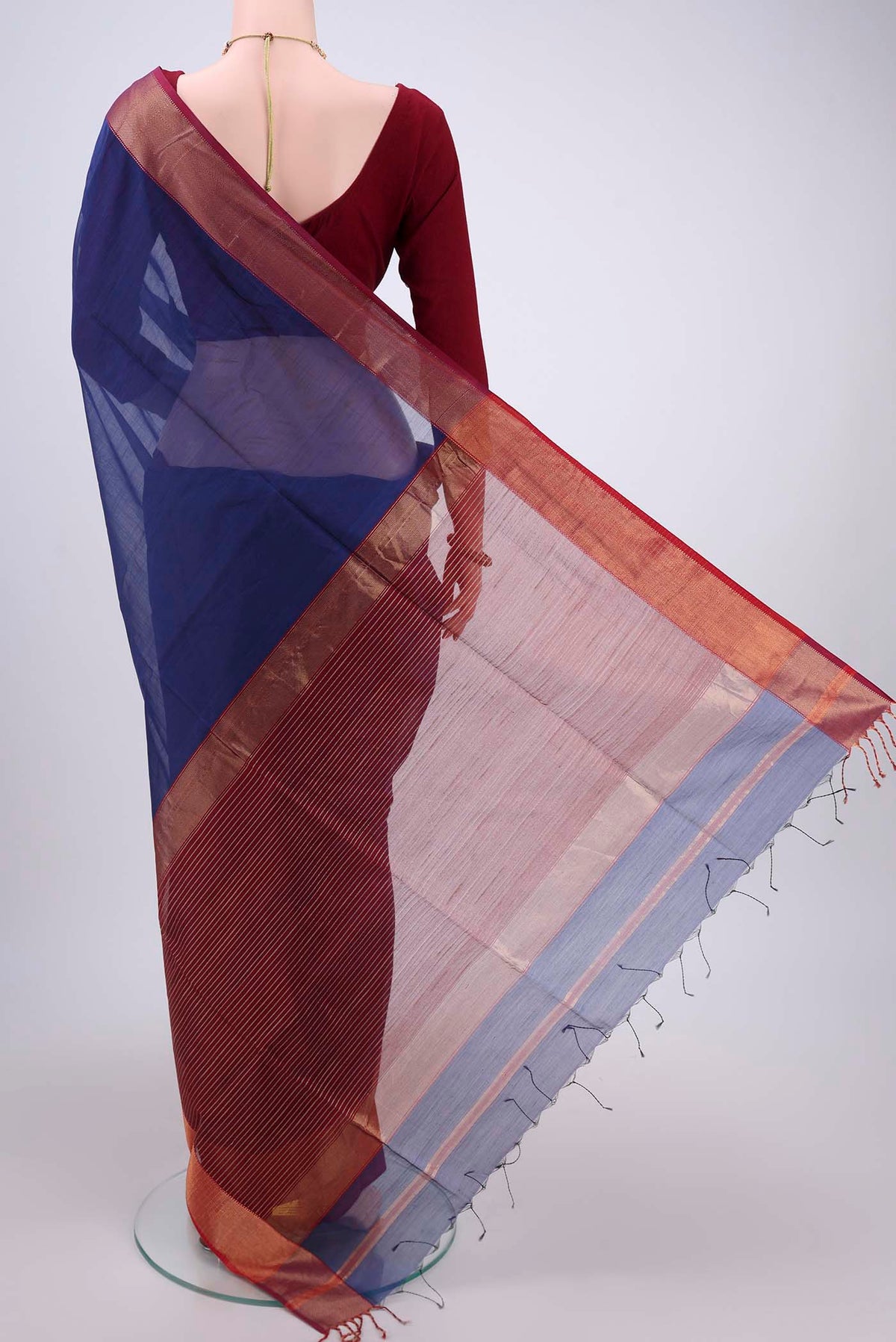 Flat view of Purple Maheshwari Silk Cotton Saree with Stripes on the body and Zari Border. 