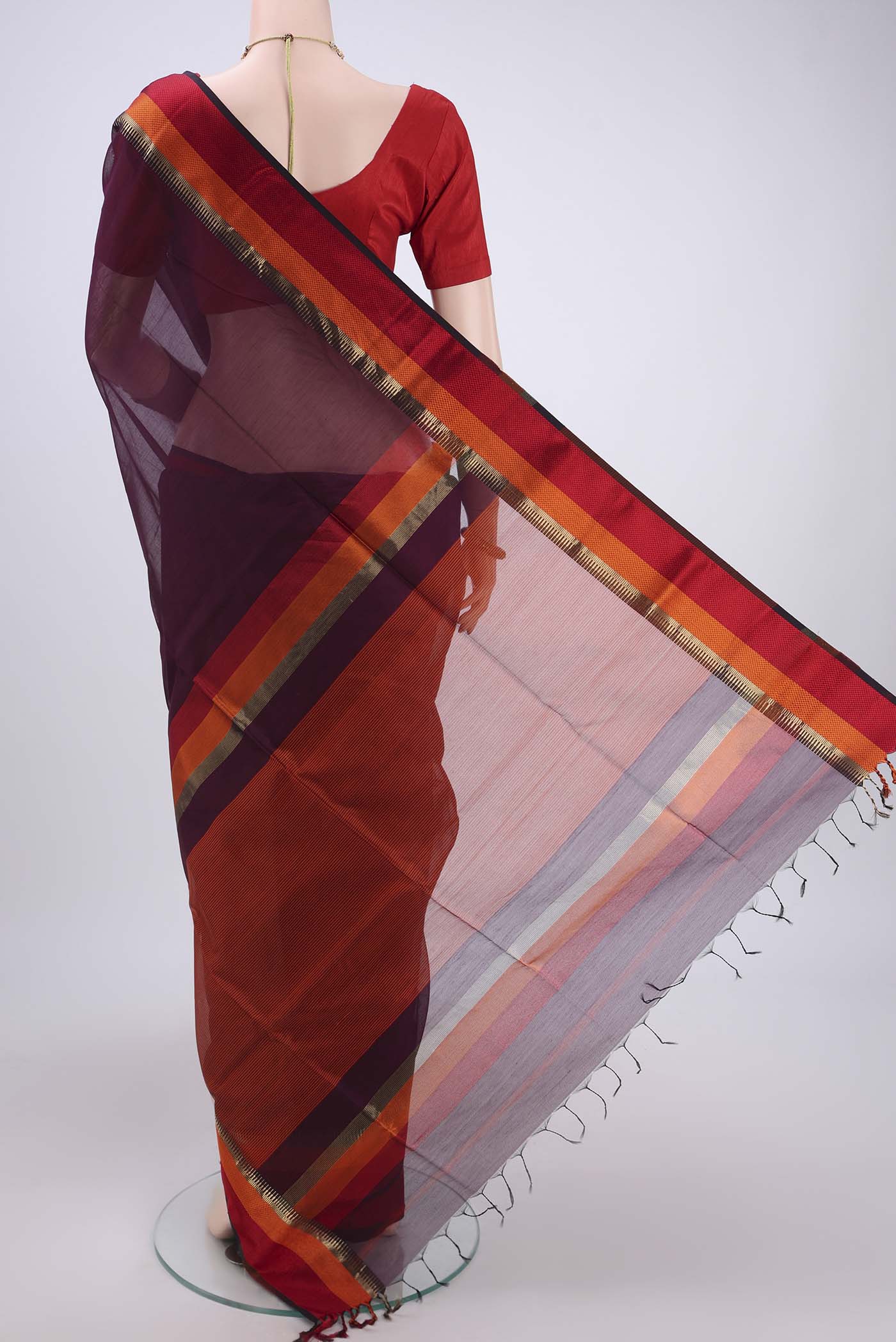 Flat view of Burgundy Maheshwari Silk Cotton Saree with Plain Body and Zari Border. 