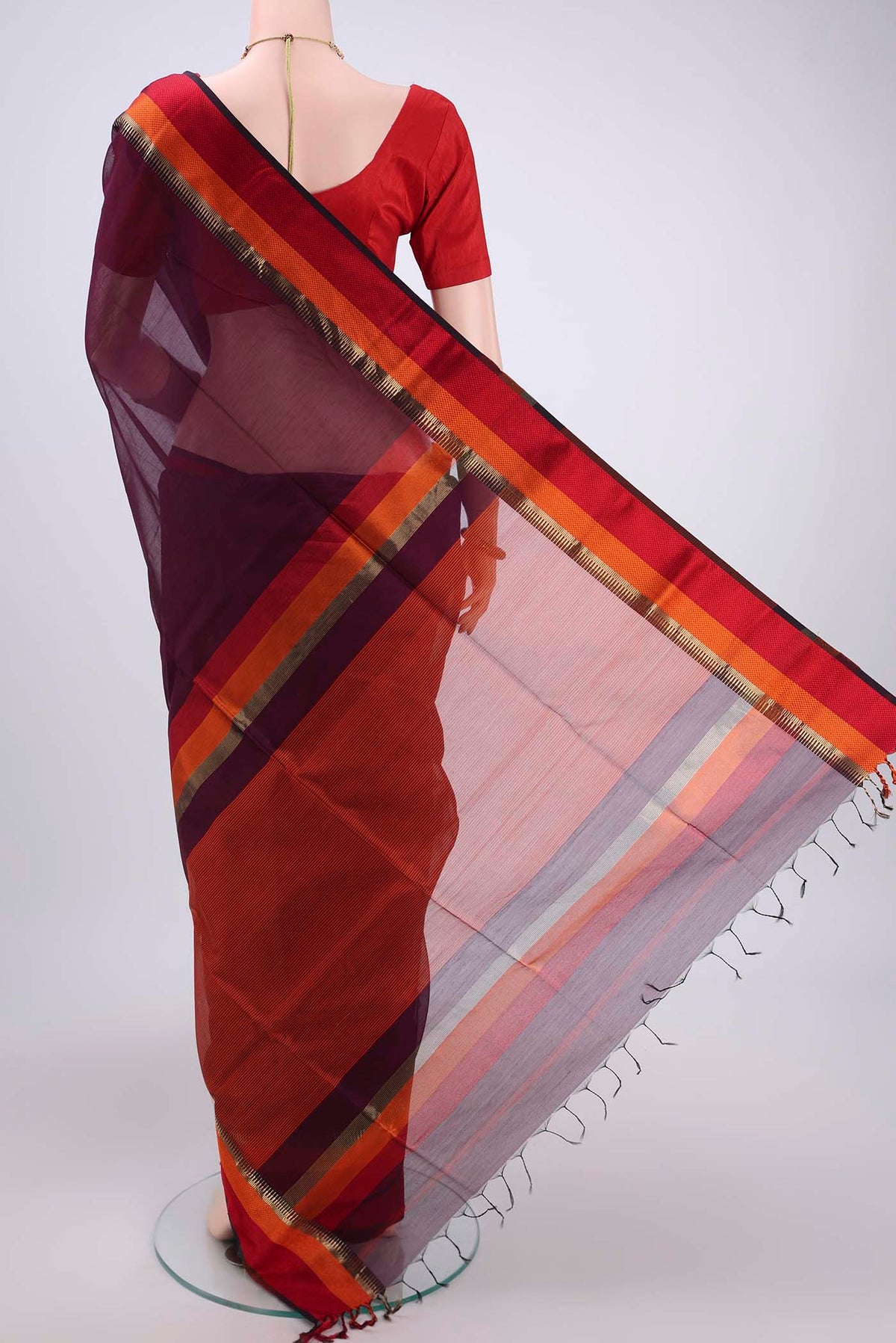 Flat view of Burgundy Maheshwari Silk Cotton Saree with Plain Body and Zari Border. 