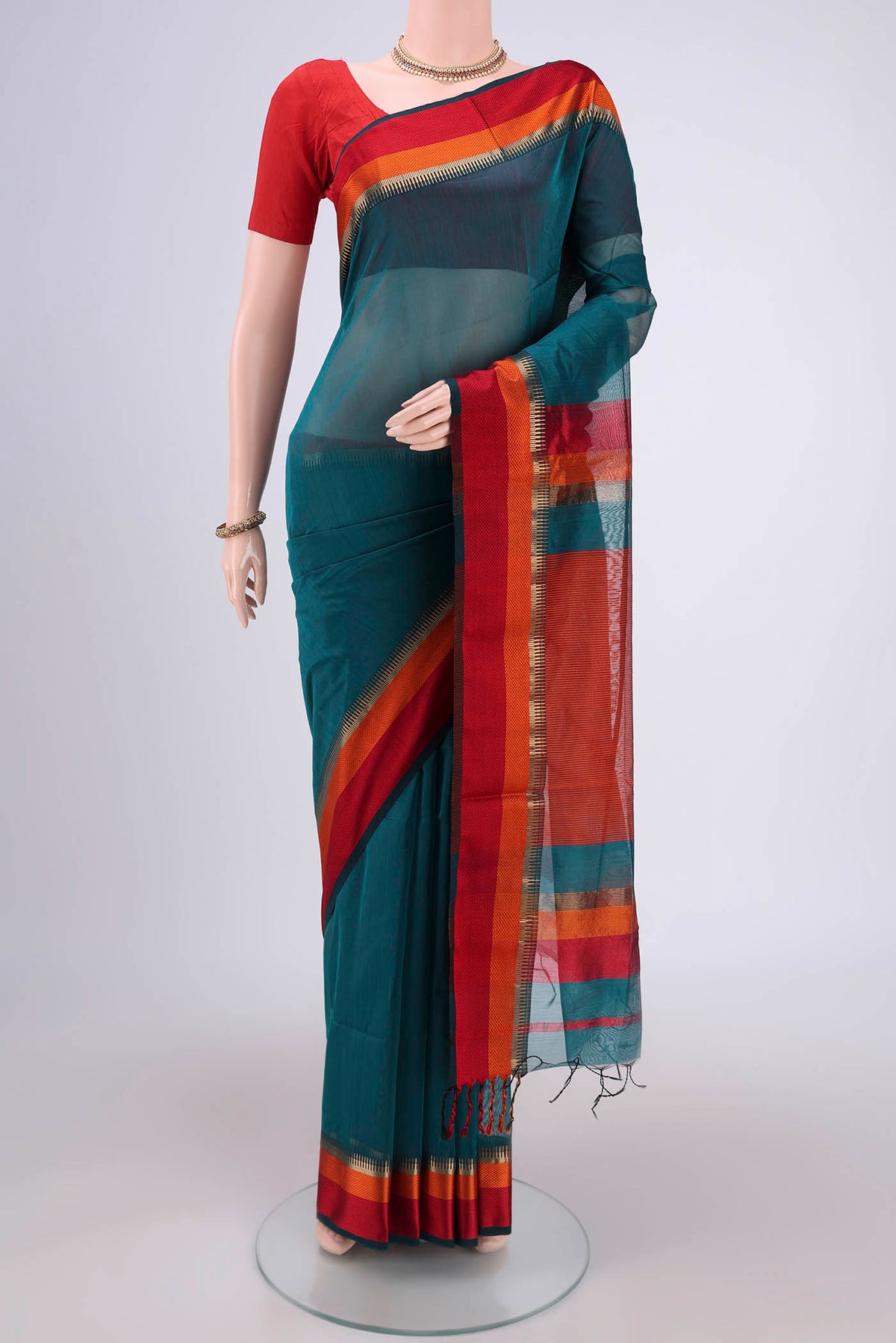 Teal Maheshwari Silk Cotton Saree with Plain Body and Zari And Thread Border.  displayed on a mannequin
