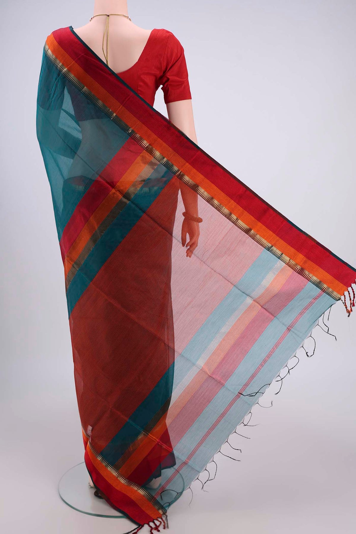 Flat view of Teal Maheshwari Silk Cotton Saree with Plain Body and Zari And Thread Border. 