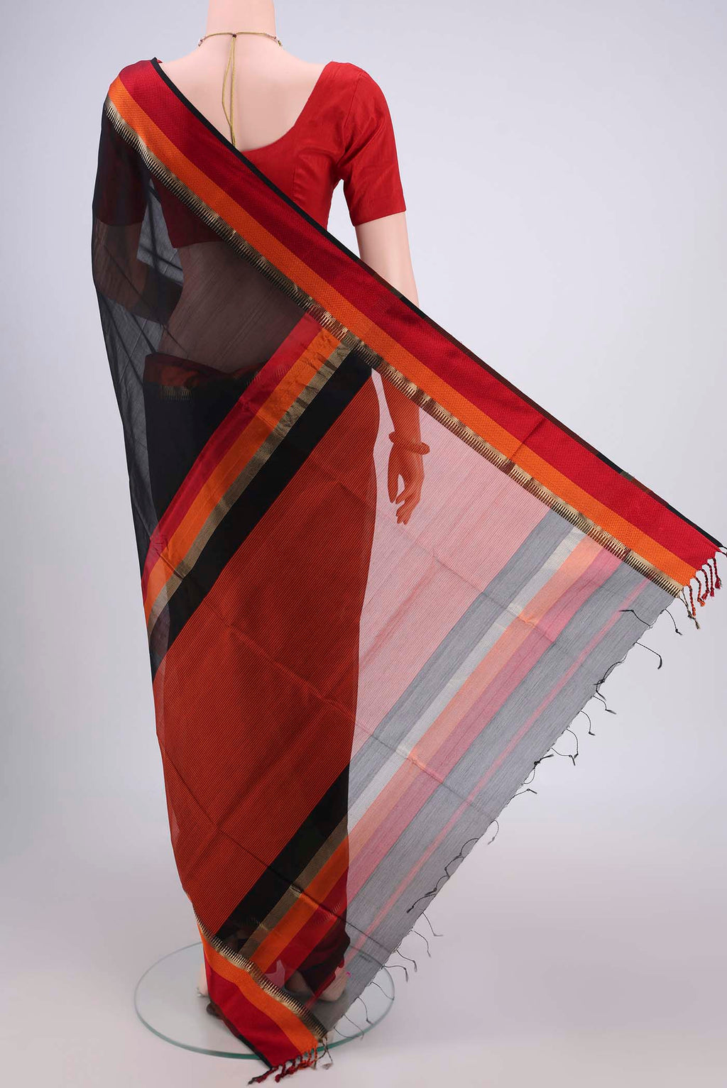 Flat view of Black Maheshwari Silk Cotton Saree with Plain Body and Zari And Thread Border. 