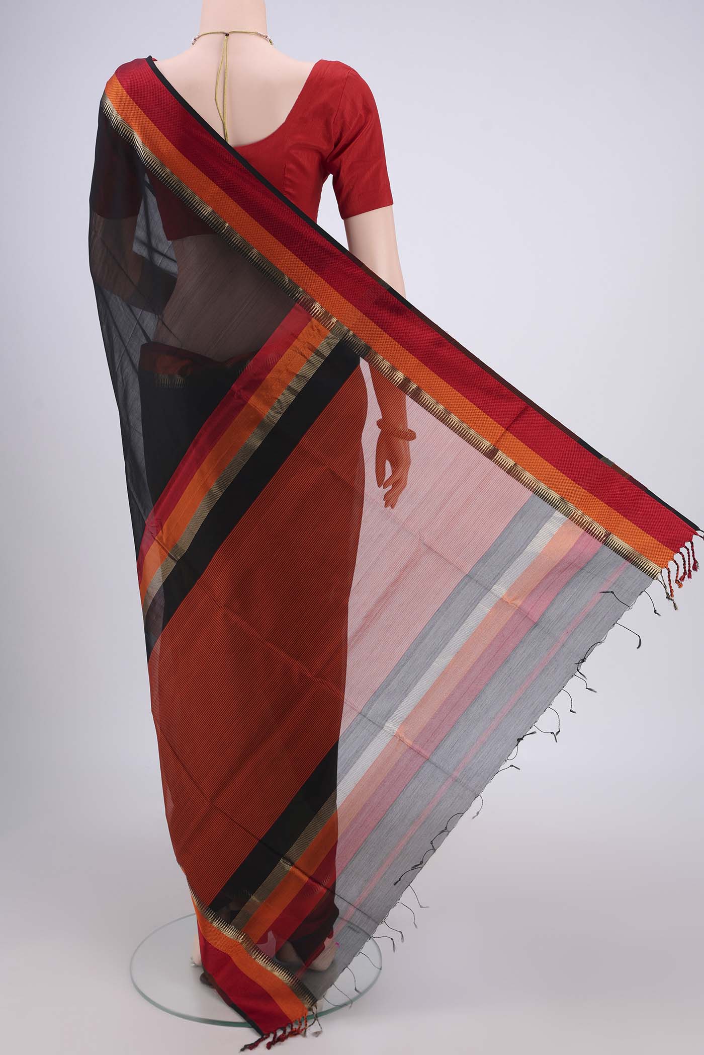 Flat view of Black Maheshwari Silk Cotton Saree with Plain Body and Zari And Thread Border. 