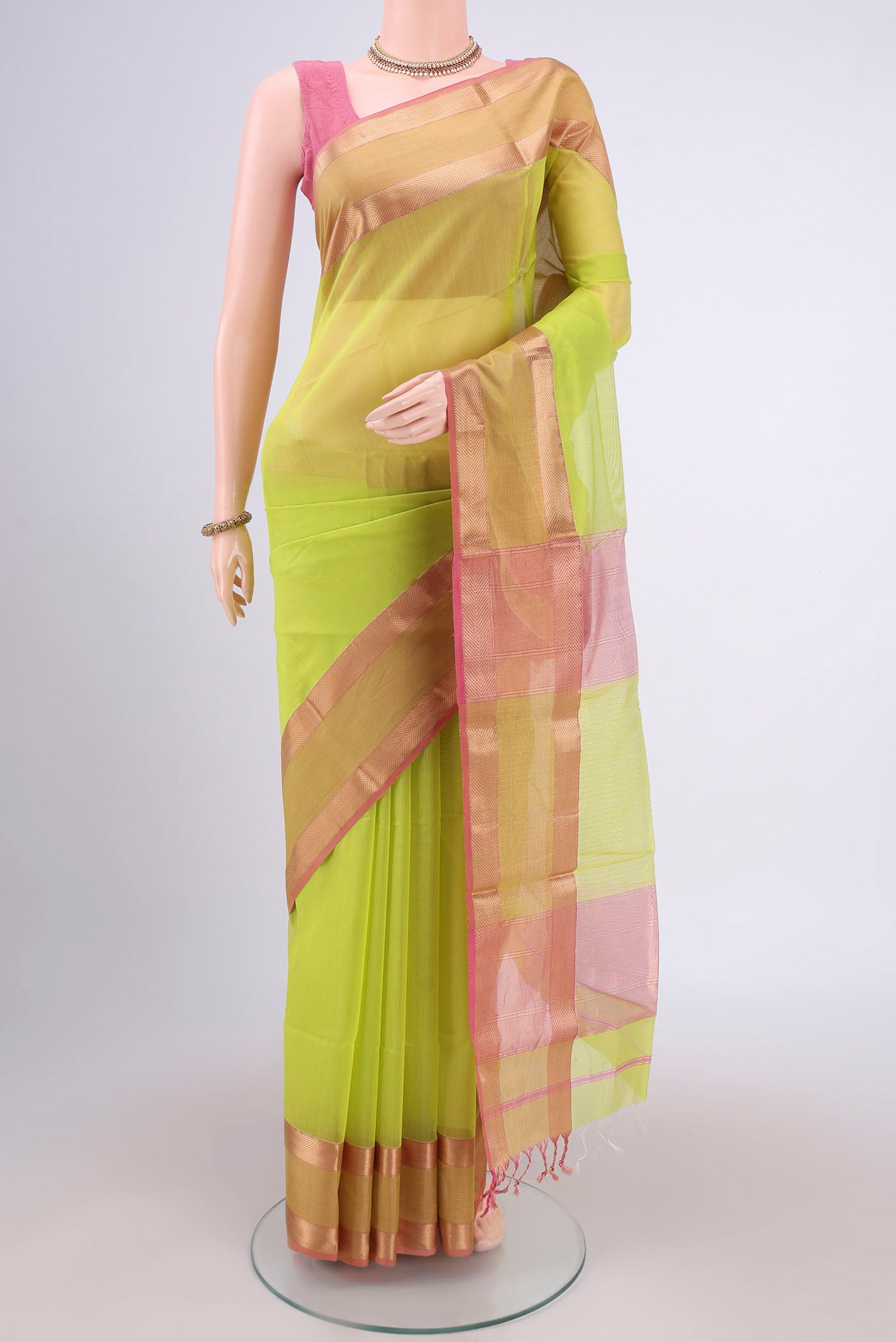 Parrot Green Maheshwari Silk Cotton Saree with Plain Body and Zari Border.  displayed on a mannequin
