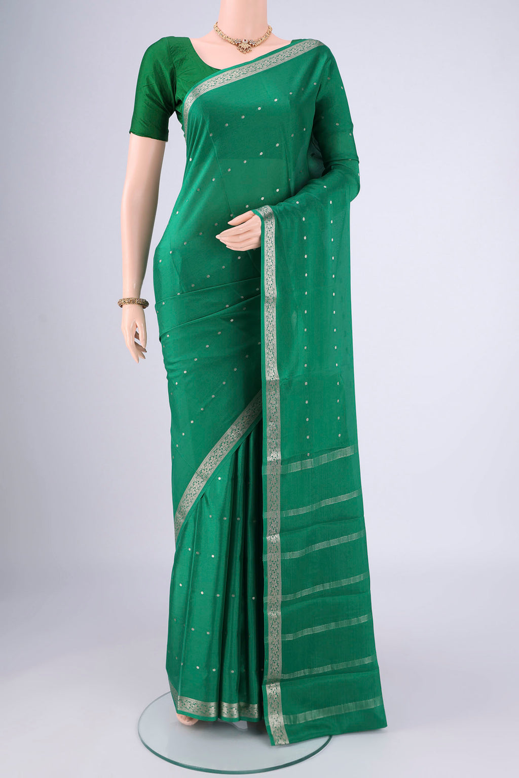 Green Mysore Crepe Saree with Zari Butta on the body and Zari Border.  displayed on a mannequin